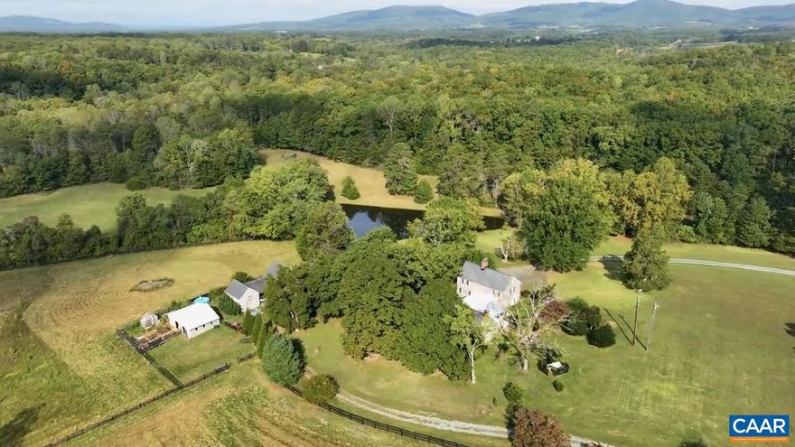 42+ ACRES, fully stocked POND, & gloriously located east of Charlottesville in Keswick Hunt Country; boasting 5 DIVISION RIGHTS! A harmonious mix of a circa 1850 ?2 over 2? log cabin and a 1970 2-story colonial; balancing original character w/ modern convenience. Partially fenced; perfect for a mini farmette. Outbuildings include a 2-car garage w/ workshop & insulated upstairs ?studio?, 2 carports, a large storage building, and a 3-section barn w/ 2 horse stalls. Ride your HORSES in the outdoor RIDING ARENA! The kitchen & butler?s pantry w/ Bosch appliances, QUARTZ counter tops, & hand painted CERAMIC tile from Jerusalem. 2024: New Heat Pump & HVAC. Bathrooms are charming in design and d�cor complete with custom tubs & one of a kind cabinetry & doors. It?s all in the details; built-in bookcases, exposed beams, French doors, beaded paneling, & elegant hardware. With 5 BRs and 2.5 baths you can decide if you prefer a 1st floor or a 2nd floor primary bedroom. Enjoy the charismatic ornamental garden w/ zen-like stone paths leading to a floral sanctuary. For the passionate, there is a greenhouse w/ raised-beds. Dream & plan out how you might use the 5 DIVISION RIGHTS; preserving a once in a lifetime opportunity for generations to come.,Quartz Counter,Fireplace in Bedroom,Fireplace in Dining Room,Fireplace in Living Room