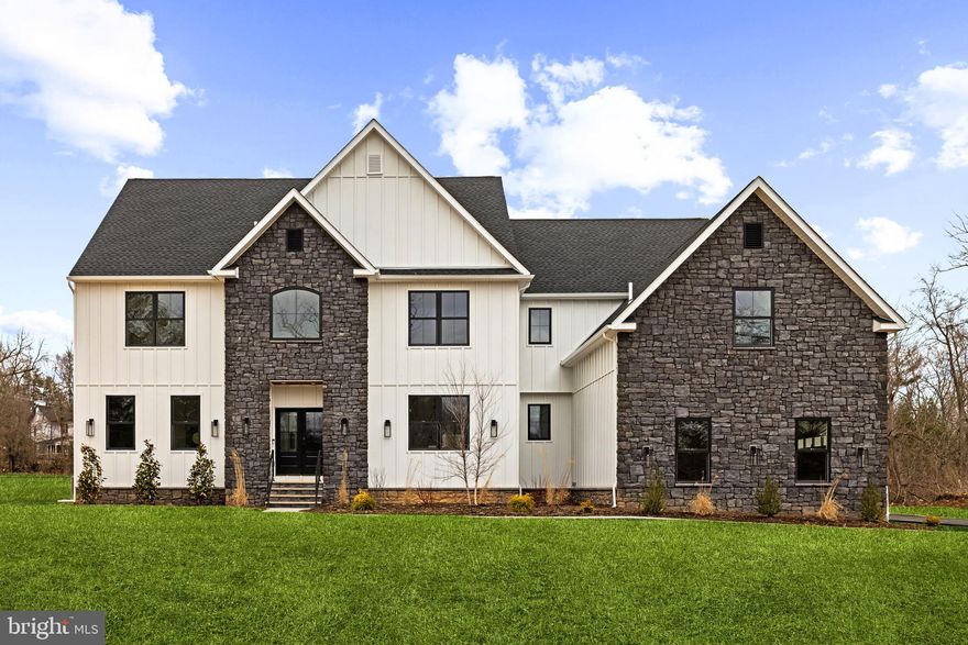 Reimagined  with extensive feedback, TENNIS POINTE continues to stand as an unrivaled testament to exceptional design, now elevated further in its new and improved Phase II iteration. Seamlessly blending the timeless elegance of Modern Colonial architecture with the rustic charm of Farmhouse aesthetics, each Phase II home offers an even more expansive floor plan than before, with every room thoughtfully enlarged for enhanced comfort & luxury. Undeniably striking, these extraordinary residences are perched atop a raised elevation, their pristine white façades accented with bold stone details. A limestone porch, accessed via a pedestrian path, welcomes you to the entrance, where you are greeted by a towering foyer. Long Leaf Acacia hardwood floors frame a stunning central staircase, setting the tone for the home's grandeur. To the left, the living room captivates with an abundance of windows inviting natural light, intricate trim work, & a breathtaking gas fireplace encased in floor-to-ceiling stone. Across the foyer is the massive formal dining room. Next, you will find a pantry with an added butler prep area. The kitchen, one of three defining focal points of this Phase II residence, is a masterpiece of form and function. Anchored by an oversized island with a waterfall edge, it features Italian Aster Cucine custom cabinetry with marble countertops, Bertazzoni stainless steel appliances—including a professional-grade 6-burner gas oven/range with hood and a JennAir® panel-ready refrigerator—& elegant pendant lighting. A beautifully tiled mudroom offers access to the side-entry door, expansive 3-car garage, and uniquely appointed private study. Featuring intricate trim work, wall sconces, and a refined ambiance, the study offers a dedicated space. Beyond the breakfast area, the great room unfolds with soaring two-story ceilings and a two-story window array, flooding the space with natural light and creating a harmonious connection to the outdoors. The main level also features a proper first-floor bedroom suite, complete with a walk-in closet and a private bathroom showcasing a frameless glass shower and majestic large-format tile. Ascending the staircase, you arrive at an open loft area that bridges the bedrooms. Two bedrooms share a Jack-and-Jill bathroom, designed with a custom floating vanity & an extra-deep tub/shower. Nearby, the laundry room is equipped with a built-in linen closet, sink, and quartz countertop for added convenience. A princess suite, with a spacious walk-in closet & en-suite bath, also offers a unique addition to Phase II. The princess suite now features access to a mezzanine, providing an elevated retreat within the home. Through French doors lies the primary suite, the second focal point of this enhanced Phase II home. This sanctuary is distinguished by a chandelier suspended from a lofty cathedral ceiling, a shiplap-clad feature wall, & two custom-organized walk-in closets. A massive balcony, exclusive to Phase II, extends from the primary suite, offering breathtaking views of the backyard. The primary bathroom is a true spa-like retreat, adorned with immaculate large-format tile. A private water closet, colossal double vanity with a dedicated makeup table, a freestanding soaking tub, and a walk-in shower with custom glass & multiple showerheads complete this oasis. The entertainment-driven lower level, the third focal point, is designed for leisure and enjoyment. It features a media room, game room, fitness area, & a full bar. An additional sixth bedroom provides accommodation for guests or family, while yet another full bathroom & walkout stairs to the backyard enhance functionality. Other exceptional features include high-efficiency dual-zone HVAC systems with NEST thermostat controls, Andersen windows, Therma-Tru exterior doors, a professionally curated landscape package, & more. TENNIS POINTE, in its new and improved Phase II form, is not merely a home—it is a masterpiece of modern luxury.