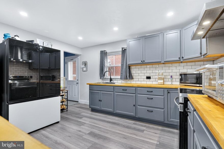 Discover an exquisite blend of contemporary elegance and timeless charm in this stunning 4-bedroom, 2 / half bath and 1 full bathroom. This detached home boasts a traditional floor plan that seamlessly integrates modern living with classic design. Split systems in the living room and each bedroom for comfort. 200 Amp with a new circuit breaker box and power surge. Step inside to find a spacious remodeled kitchen with wood butcher block countertops, sleek stainless steel appliances, and a deep stainless steel sink. The inviting living area features a cozy and modern living room space with laminated flooring, creating an ambiance of warmth and sophistication and to top it off the eye catching stainless steel railings leading to the second floor. The partially finished basement with laminated flooring offers endless possibilities, whether for a home gym, entertainment space, or additional storage. Enjoy the luxury of outdoor living with a charming balcony, expansive deck, and welcoming porch, ideal for entertaining or simply unwinding in your private rear yard. This property provides ample off-street parking with an asphalt driveway accommodating up to four vehicles. A remodeled shed with laminated flooring, insulated with electricity.  The urban location ensures convenience, with a bus stop less than a mile away, making commuting a breeze. Experience the exclusive lifestyle this home offers, where every detail has been thoughtfully curated for comfort and modern style. Don't miss the opportunity to make this your own!