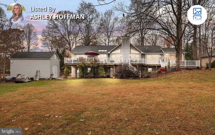 Welcome to Lake Anna living where laughter echoes across the water, summer lasts a little longer, and memories are made on repeat! That's what you'll experience at this beautiful waterfront retreat tucked away on the peaceful private side of the lake in the desirable Overton Fork subdivision, with high-speed fiber Firefly internet. With 225 feet of protected shoreline, a covered boathouse with a 6,000 lb lift, sun deck, storage room, and even a jet ski pad, your biggest decision each day will be: boat, float, or both? Inside, more than 2,800 finished square feet of thoughtfully designed space invites friends and family to gather and relax. The great room welcomes you with soaring vaulted ceilings and a stunning stone gas fireplace that flows right into the dining area and a 2022-remodeled kitchen, complete with sleek quartz counters, a breakfast bar, tile backsplash, and new appliances—yes, including a Bosch dishwasher for easy clean-up after lake-day feasts! When it’s time to unwind, the lakeside primary suite feels like a private escape with deck access, a custom walk-in closet, and a show-stopping bathroom (redone in 2023) featuring a large tiled shower, double vanity with WiFi LED mirror, radiant heated floors, and plantation shutters. Two additional bedrooms, a full bath, laundry room, and half bath complete the main level. The fun continues downstairs in the finished walkout basement, where movie nights, game days, and celebrations come alive. Cozy up by the gas stove, serve drinks at the bar, stock the beverage cooler and ice-maker, and store your favorites in the wine closet. An additional bedroom and full bath make it perfect for guests who'll never want to leave. Step outside and soak up everything Lake Anna living is about—a large composite deck with an outdoor kitchen, a hot tub for stargazing, screened porch for relaxing with a book in hand, and a lakeside fire-pit for roasting s'mores, sharing stories, and late-night laughs. The 1.01 acre level lot is made for lawn games, picnics, and easy walks right to the water. Oversized 2-car garage, paved driveway, insulated two-story shed with power and upper storage, 22 KW Generac generator, tankless water heater, fiber internet, Hybrid HVAC with propane backup, and a 30 Amp RV hookup, gives you the total package; comfort, convenience, and lakefront living done right. Pack your swimsuits, bring your boat, and get ready to create the kind of memories people talk about for a lifetime. Welcome home to Lake Anna! This neighborhood does allow short term rentals. See full list of improvements in MLS documents section.