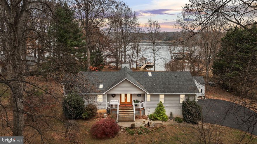 Welcome to Lake Anna living where laughter echoes across the water, summer lasts a little longer, and memories are made on repeat! That's what you'll experience at this beautiful waterfront retreat tucked away on the peaceful private side of the lake in the desirable Overton Fork subdivision, with high-speed fiber Firefly internet. With 225 feet of protected shoreline, a covered boathouse with a 6,000 lb lift, sun deck, storage room, and even a jet ski pad, your biggest decision each day will be: boat, float, or both? Inside, more than 2,800 finished square feet of thoughtfully designed space invites friends and family to gather and relax. The great room welcomes you with soaring vaulted ceilings and a stunning stone gas fireplace that flows right into the dining area and a 2022-remodeled kitchen, complete with sleek quartz counters, a breakfast bar, tile backsplash, and new appliances—yes, including a Bosch dishwasher for easy clean-up after lake-day feasts! When it’s time to unwind, the lakeside primary suite feels like a private escape with deck access, a custom walk-in closet, and a show-stopping bathroom (redone in 2023) featuring a large tiled shower, double vanity with WiFi LED mirror, radiant heated floors, and plantation shutters. Two additional bedrooms, a full bath, laundry room, and half bath complete the main level. The fun continues downstairs in the finished walkout basement, where movie nights, game days, and celebrations come alive. Cozy up by the gas stove, serve drinks at the bar, stock the beverage cooler and ice-maker, and store your favorites in the wine closet. An additional bedroom and full bath make it perfect for guests who'll never want to leave. Step outside and soak up everything Lake Anna living is about—a large composite deck with an outdoor kitchen, a hot tub for stargazing, screened porch for relaxing with a book in hand, and a lakeside fire-pit for roasting s'mores, sharing stories, and late-night laughs. The 1.01 acre level lot is made for lawn games, picnics, and easy walks right to the water. Oversized 2-car garage, paved driveway, insulated two-story shed with power and upper storage, 22 KW Generac generator, tankless water heater, fiber internet, Hybrid HVAC with propane backup, and a 30 Amp RV hookup, gives you the total package; comfort, convenience, and lakefront living done right. Pack your swimsuits, bring your boat, and get ready to create the kind of memories people talk about for a lifetime. Welcome home to Lake Anna! This neighborhood does allow short term rentals. See full list of improvements in MLS documents section.