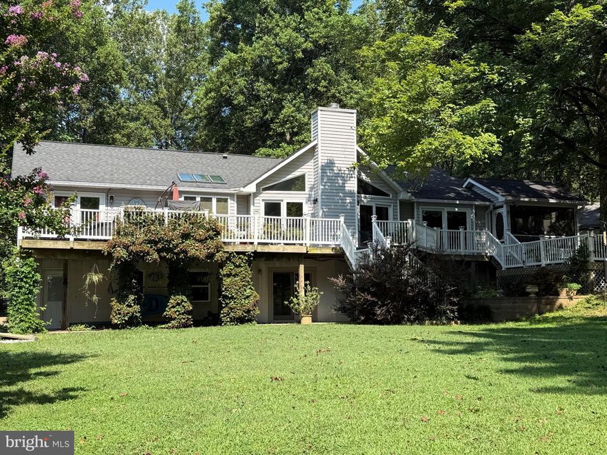 Welcome to Lake Anna living where laughter echoes across the water, summer lasts a little longer, and memories are made on repeat! That's what you'll experience at this beautiful waterfront retreat tucked away on the peaceful private side of the lake in the desirable Overton Fork subdivision, with high-speed fiber Firefly internet. With 225 feet of protected shoreline, a covered boathouse with a 6,000 lb lift, sun deck, storage room, and even a jet ski pad, your biggest decision each day will be: boat, float, or both? Inside, more than 2,800 finished square feet of thoughtfully designed space invites friends and family to gather and relax. The great room welcomes you with soaring vaulted ceilings and a stunning stone gas fireplace that flows right into the dining area and a 2022-remodeled kitchen, complete with sleek quartz counters, a breakfast bar, tile backsplash, and new appliances—yes, including a Bosch dishwasher for easy clean-up after lake-day feasts! When it’s time to unwind, the lakeside primary suite feels like a private escape with deck access, a custom walk-in closet, and a show-stopping bathroom (redone in 2023) featuring a large tiled shower, double vanity with WiFi LED mirror, radiant heated floors, and plantation shutters. Two additional bedrooms, a full bath, laundry room, and half bath complete the main level. The fun continues downstairs in the finished walkout basement, where movie nights, game days, and celebrations come alive. Cozy up by the gas stove, serve drinks at the bar, stock the beverage cooler and ice-maker, and store your favorites in the wine closet. An additional bedroom and full bath make it perfect for guests who'll never want to leave. Step outside and soak up everything Lake Anna living is about—a large composite deck with an outdoor kitchen, a hot tub for stargazing, screened porch for relaxing with a book in hand, and a lakeside fire-pit for roasting s'mores, sharing stories, and late-night laughs. The 1.01 acre level lot is made for lawn games, picnics, and easy walks right to the water. Oversized 2-car garage, paved driveway, insulated two-story shed with power and upper storage, 22 KW Generac generator, tankless water heater, fiber internet, Hybrid HVAC with propane backup, and a 30 Amp RV hookup, gives you the total package; comfort, convenience, and lakefront living done right. Pack your swimsuits, bring your boat, and get ready to create the kind of memories people talk about for a lifetime. Welcome home to Lake Anna! This neighborhood does allow short term rentals. See full list of improvements in MLS documents section.