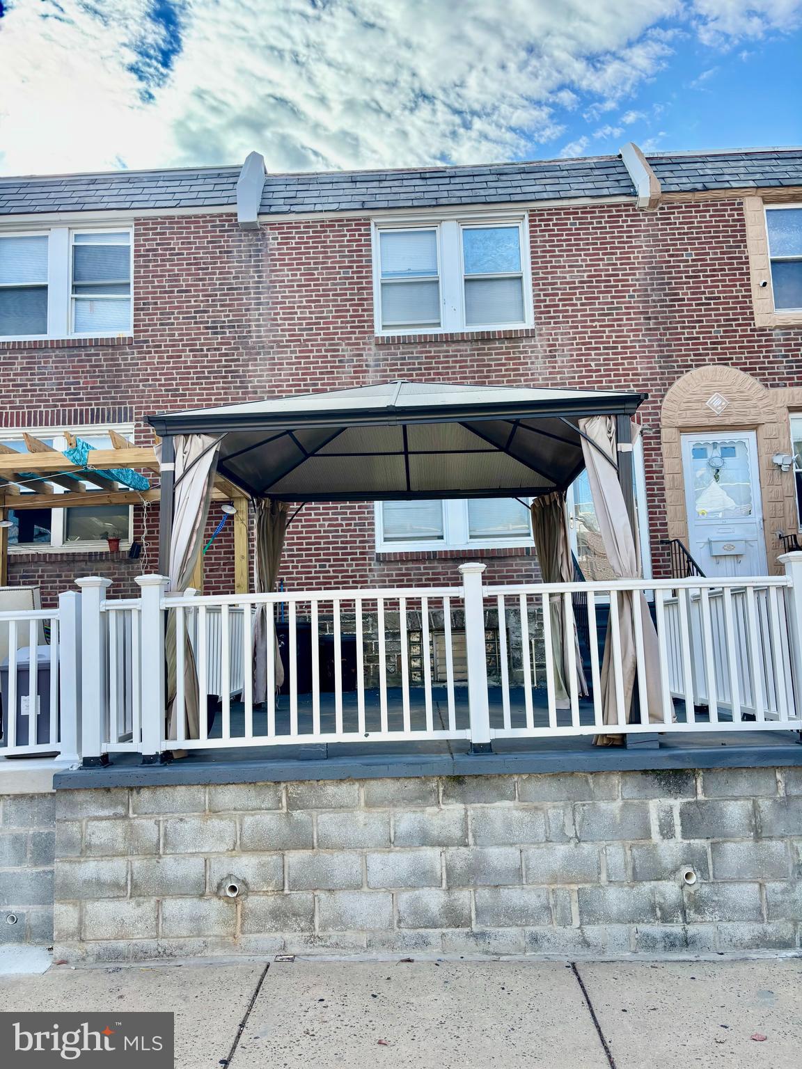 Welcome to this charming townhouse featuring an outdoor fenced patio with gazebo, perfect for entertaining or relaxing. The main level offers a spacious living room with a coat closet, an open kitchen with an island providing additional countertop space, cabinetry, and seating, as well as a dining room with ceramic tile flooring. The upper level includes three comfortable bedrooms and an updated full bathroom. Conveniently located close to public transportation, shopping, and schools.