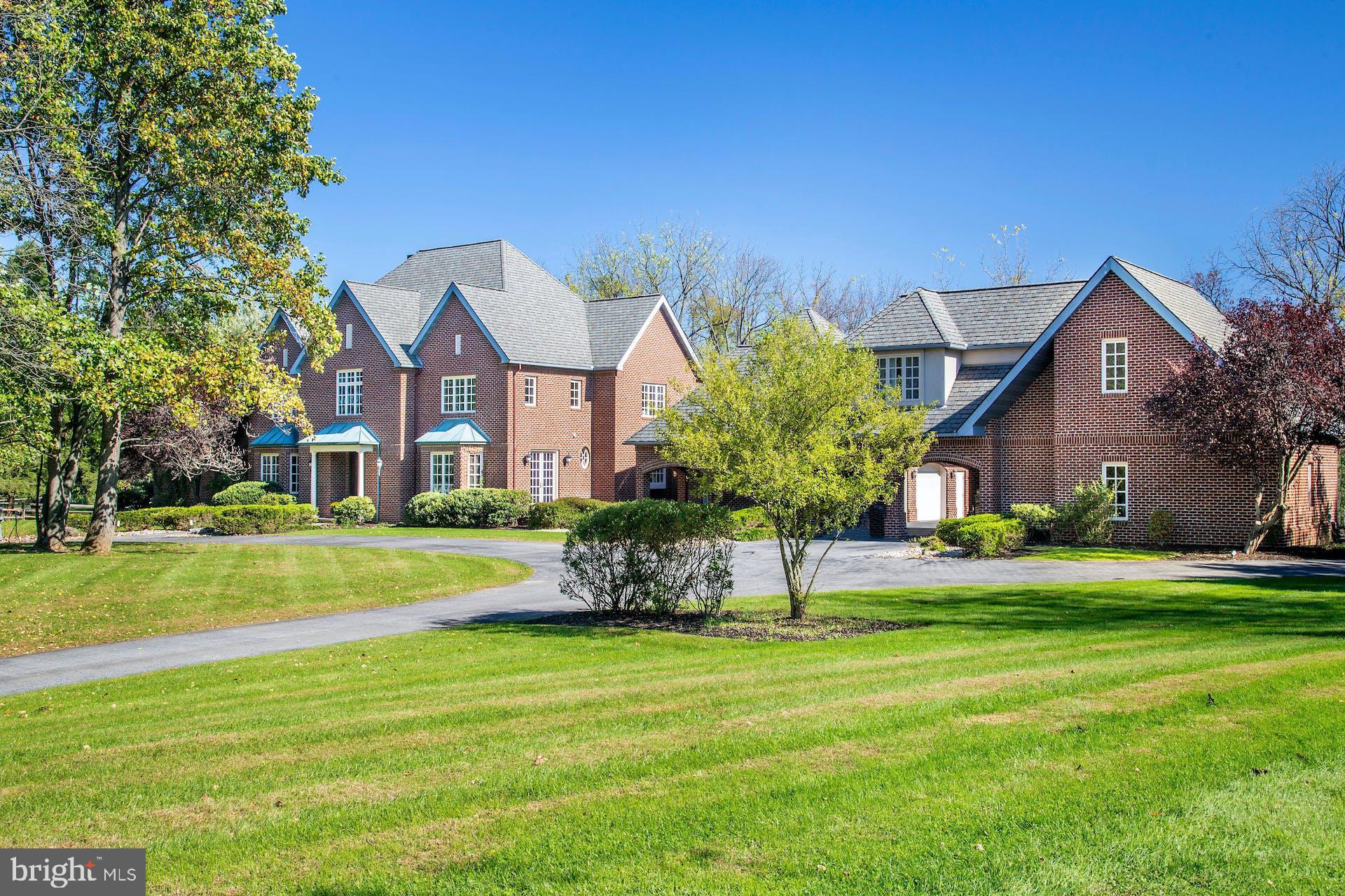 It is a rare pleasure to encounter such a Saucon Valley property, set amidst rich landscaping & glorious gardens, on a park-like 2.4 acres. Wildberry is designed to take full advantage of an ideal location at the end of a Saucon Valley cul-de-sac. Nearby, the residences are unique, both for their timelessness & for their ability to reflect the natural surroundings in their design, with an orientation towards spectacular landscapes, Wildberry is an example of this marriage of land & home. Truly beyond the imagination and enticing one to stay forever, Wildberry is a premiere estate property. The timeless design offers a floor plan featuring spacious rooms in more than 9,686 sqft on 3 levels. A wealth of custom details & a sophisticated, yet functional, floor plan attest to a thoughtful design. Romantic details combine with ceramic, marble, wood & granite accents to create a rich & warm atmosphere in spaces of grand proportions that invite one to entertain. The living room is highlighted by a southwest style fireplace, creating an inviting ambiance & serving as a dramatic introduction to the rooms to come. The gourmet kitchen was designed as the heart of the home and plays its part with ease. The appliances are top-of-the-line, with both Dacor gas & Jenn Aire cooktops, 2 Asko dishwashers, Sub-Zero refrigerator, freezer, freezer drawers & refrigerator drawers, & Dacor double ovens. 2 center islands with granite counters make cooking & entertaining a breeze. Custom cabinets, wet bar, home office & pantry provide the perfect complement for entertaining as well. Steps away, the great room boasts a beamed cathedral ceiling, walls of glass, & a floor-to-ceiling stone fireplace. Also on the 1st floor is a formal dining room with walls of glass to the front courtyard, an office & an exercise room. Completing the 1st floor, a master bedroom features a wood-burning fireplace, cathedral ceilings, floor to ceiling windows, & doors to a private, walled, back patio. The master bath & walk-in closets will provide fabulous additional spaces to pamper and soothe. On the 2nd floor there are 4 additional bedrooms, while a 3rd floor retreat with full bath offers a variety of uses for extended living space. Finally, the lower level has abundant room waiting to be finished with amenities such as a home theatre & any additional family needs one might envision. Outside, the home is serenely set & prominently positioned, enveloped by mature trees, manicured lawns, & perennial gardens. There are lovely outdoor living spaces with patios & private vistas, all overlooking a Koi pond, pool & spa … in a bucolic setting of natural beauty. A 2-car garage is attached, & a porte-cochere adds 2 additional garages with a fully finished guest suite above. It is a privilege to experience such a home & a special joy to offer this property for sale.
