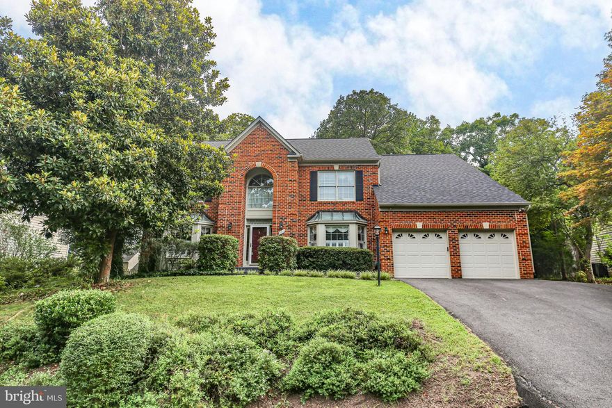 Welcome to this beautifully maintained 4-bedroom, 4.5-bath home offering over 4,350 finished square feet of living space across three levels. Nestled on a .33-acre lot in the highly sought-after community of Fox Point, this stately brick-front Colonial showcases a double-bay window façade, elegant metal roof accents, and a soaring two-story foyer that floods the entryway with natural light. 

The main level boasts hardwood flooring throughout, a formal living room and dining room with custom plantation shutters, box molding, and elegant fixtures. A home office with French doors sits just off the foyer—perfect for those working from home. At the heart of the home is a stunning family room with vaulted ceilings, a dramatic two-story brick wood-burning fireplace framed by Palladian windows, and a built-in wet bar with granite countertops, wine storage, and sink—ideal for entertaining. French doors lead to a spacious deck for seamless indoor-outdoor living.

The kitchen is a chef’s dream, featuring a two-tier island with barstool seating, a gas cooktop, pendant lighting, and granite countertops. You’ll love the under-cabinet lighting, cabinetry that extends to the ceiling, double wall ovens, pantry, glass-front cabinets, and a bright breakfast nook with two full-light doors to the deck. Just off the kitchen, a large mudroom connects to the oversized 2-car garage with ample storage—and a second refrigerator that conveys!

Upstairs, the generously sized primary suite features cathedral ceilings, and an enormous en suite bath with  stall shower, soaking tub beneath a picture window, double vanity, built-in makeup station, and abundant cabinet storage. Three additional bedrooms provide comfortable accommodations with plush carpet underfoot. Two bedrooms share a Jack and Jill bath, while the third enjoys access to a private hall bath. At the end of the upper level, a rear staircase overlooks the family room and offers casual access back to the main level.

The finished basement expands the living space with a large recreation room featuring recessed lighting and Berber-style carpet, a full bathroom with LVP flooring, a laundry room with utility sink, multiple storage areas and a second bonus space with another wet bar and multiple closets. There's plenty of room for all your board games and toys in the double closet. The unfinished storage room also offers built-in shelves and plenty of space for seasonal decor.

Your outdoor space adds to the charm of this home. The deck is accessible from the kitchen and family room so you can open the French doors and expand your entertainment space. The rear yard is fenced and offers dappled sunlight and shade for a beautiful outdoor retreat. The shed offers additional storage for lawn equipment as well as room for toys and lawn games. 

This home blends timeless charm with modern comfort and offers plenty of space to live, work, and entertain. With a new roof already in place, you can rest easy knowing one of the biggest updates is already taken care of. Don't miss your opportunity to make it yours! Located just minutes from the VRE, commuter lots, shopping, schools, HCA Hospital, and the largest VA Health Clinic in the country, this amenity-rich neighborhood combines convenience with community. Fox Point residents enjoy access to a community pool, tennis and pickleball courts, playgrounds, ball fields, sand volleyball and a clubhouse.