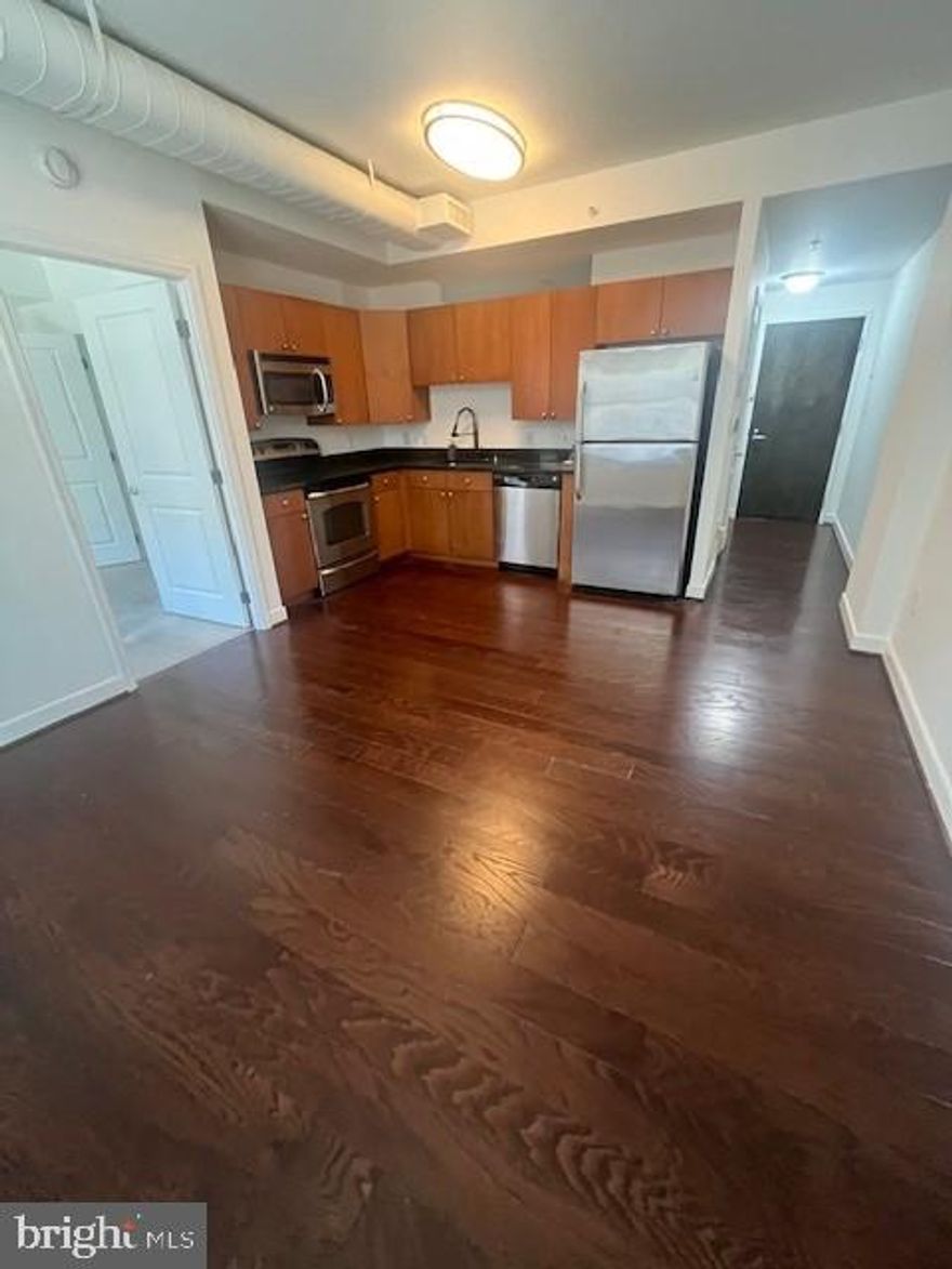 Beautiful condo with hardwood, ceramic tile, new carpet and freshly painted. Kitchen features stainless steel appliances and granite counters. Bonus area at entry can be used for guest room or office. Bedroom has large walk-in closet and shower/tub bathroom with tiled flooring. Condo is one block from waterfront and within steps to fine dining, shopping and so much more. Building has gym, rooftop pool, elegant lobby and underground assigned parking. Only minutes to DC and Northern Virginia as well.