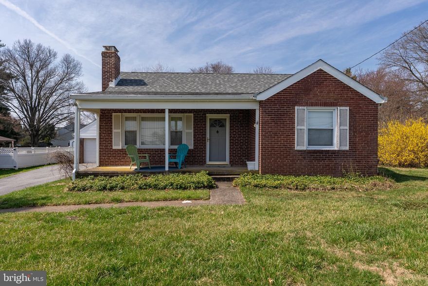 Welcome to this charming brick-front rancher set on a beautiful lot in a peaceful and established setting, complete with a covered front porch that adds to its inviting curb appeal.  As you enter, you’re welcomed into a bright family room with hardwood floors, a wood-burning brick fireplace with mantel, and a ceiling fan, along with a large window overlooking the front yard. The dining room, also with hardwood floors, is just off the kitchen and offers access to the rear deck and spacious, level backyard. The kitchen provides access to the driveway as well as an expansive upper-level bonus space, offering flexibility for a variety of uses.  Completing the main level are two bedrooms and an updated bathroom with a tub/shower combination.  The lower level offers additional space with a washer and dryer and plenty of room to customize to your needs.  Outdoor features include a detached two-car garage with a floored attic above for extra storage, as well as a shed.  Recent updates include the main level bathroom, a roof approximately 8 years old, and a recently replaced well pump.