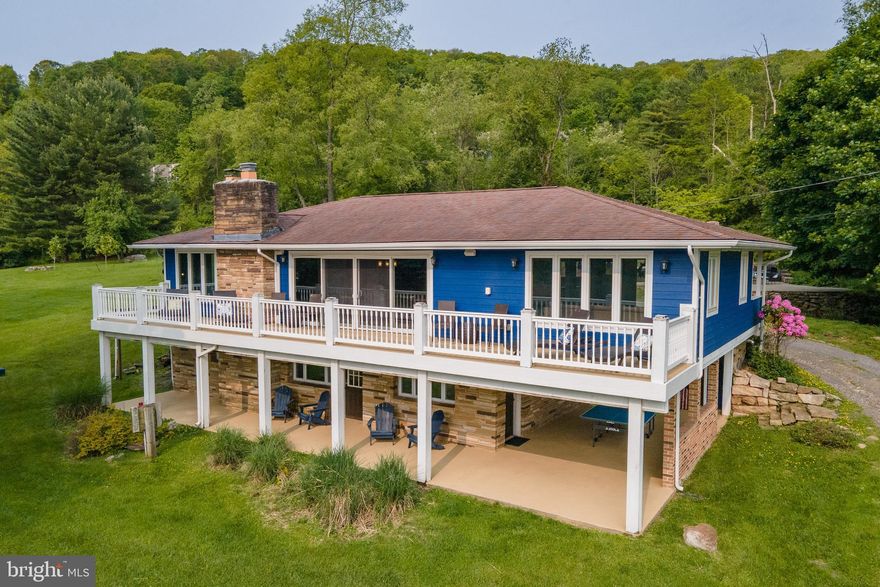 Split lakefront home at Deep Creek Lake with level lake access and a Type A dock! Mountain and Lake views right off the front porch. Minutes from the slopes at Wisp. Five bedrooms. Three full baths. 3,052 finished square feet spread over two floors. Raised ranch with wide-open living-space and a walkout basement, providing ample living space for multiple families. A stone fireplace anchors both the upper and lower levels. Gorgeous tiled shower off the primary bedroom. Recent facelift with fresh paint inside and out. New flooring, and upgraded dishwasher and refrigerator. New indoor and outdoor furniture. Two stories of sprawling outdoor living space including a deck, hot tub, and covered terrace with a wood burning fireplace. Detached three-car garage with its own new doors and a fresh coat of paint. An established vacation rental, “Cool Change” offers convenient lake-access in a prime location. Call today for details!