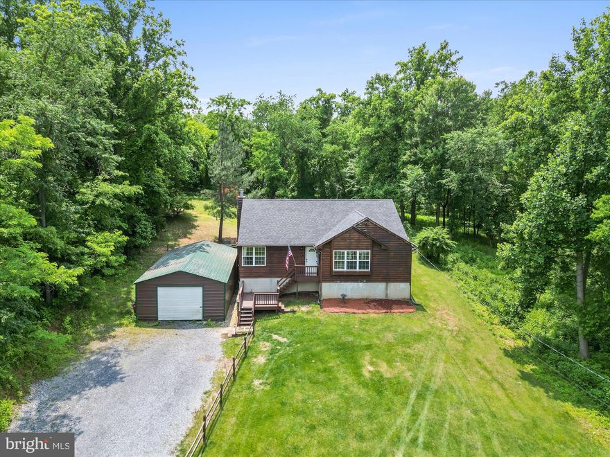 Welcome to your private retreat in the desirable John Brown Farm community, where nature meets comfort and convenience. This beautifully maintained 3-bedroom, 3-bath home sits on over an acre of serene land with private access to the Shenandoah River and immediate trail access abutting the Appalachian Trail—perfect for outdoor enthusiasts seeking adventure just beyond their doorstep. Step inside to a bright, open main level where lofted ceilings and abundant natural light accentuate the spacious kitchen and living area. To the right, the primary suite offers a peaceful escape with a garden soaking tub, while two additional bedrooms and a full hall bath with a shower/tub combo provide space and flexibility for family or guests. The fully finished lower level opens to ground level and offers exciting potential as a separate living area. It features a large rec room, a full bath, two bonus rooms with closets—ideal for office space, guest quarters, or hobbies—and a possible kitchenette area already in place. A detached garage adds convenience, while the natural privacy of the wooded surroundings brings daily visits from deer, birds, and the gentle calm of the outdoors. With only the faintest sense of nearby neighbors, this home offers a unique blend of community and seclusion, all within reach of Harpers Ferry’s historic charm and stunning natural beauty. Whether you're looking for a full-time residence or a weekend getaway, this rare property combines comfort, nature, and adventure in one unforgettable package.