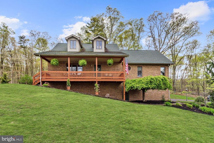 Beautiful luxury at its finest with this traditional style home that sits on almost 100 acres of secluded perfection! Arrive through the front porch and experience the main level featuring gorgeous oak vaulted ceiling and flooring, skylights, Saltillo Mexican tile, stunning two-sided gas fireplace with brick surround and natural mantle, antique lighting, slate floors, and exposed beams. Let the gourmet kitchen inspire your inner chef boasting ceramic tile, stainless steel appliances, and decorative backsplash. Relax and unwind in the master suite highlighted by a cathedral ceiling with picture windows, access to the private deck, double vanity, jetted soaking tub, and gas fireplace. The fully finished lower level family room provides the third gas fireplace, crown molding, carpet, game area, and wet bar. Ideal for any entertaining occasion with marvelous landscaped grounds, hot tub, pavilion, pergola, fire pit, kennel, and views of stunning mature trees. Large 30' x 40' detached garage and two large barns provide you with ample outdoor storage. The house is also outfitted with a backup wood-burning furnace that will heat the whole house. Optional subdivision available offering home with a 5-acre lot at a discounted price. Ask listing agent for details. Major commuter routes include US-522, US-30, and I-70.  Updates: Refrigerator (2016), New Central VacMotor (2018).   http://tour.homevisit.com/mls/295134