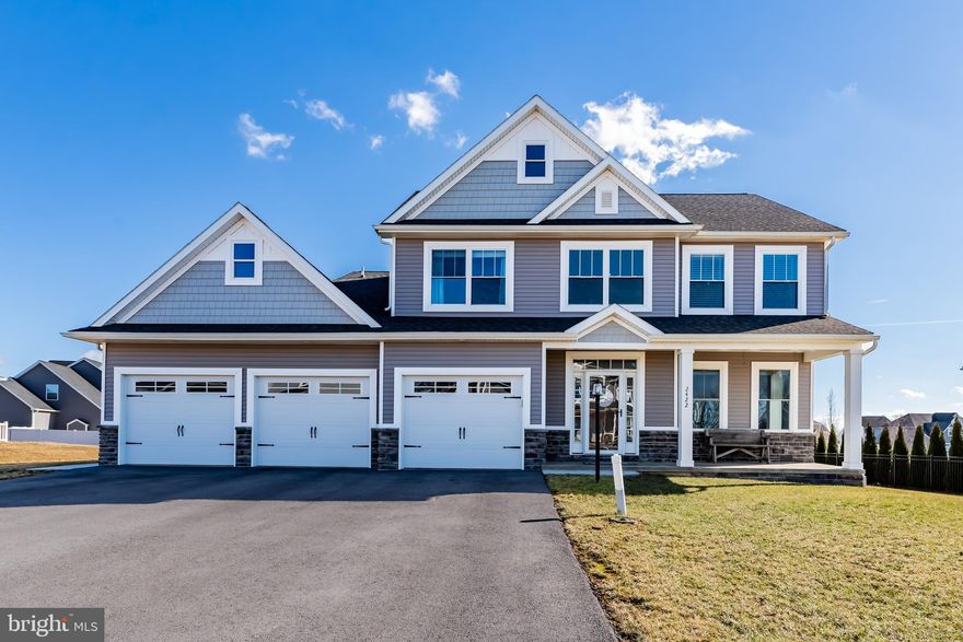 Extraordinary, better than new Grand Point Crossing home with numerous upgrades.  Enter the open 2-story foyer to a spacious formal dining room with crown molding, chair rail and shadow boxing throughout. Beyond lies an expansive open concept living space, seemlessly connecting the kitchen, breakfast nook and family room - all unified by European style 100% waterproof floors and recessed lighting, an exceptional area for entertaining.   The kitchen is a chef's dream featuring granite counters with subway tile backsplash, a farmhouse sink, pot filler, stainless steel appliances, including an upgraded Kitchen Aid gas range.  The  oversized, custom, waterfall kitchen island  contains an extra sink, cabinets on both sides, plenty of counter seating, perfect for both meal prep and casual dining. This area allows for multiple people to be cooking and multiple food stations to be set up.  The pantry, also an upgrade, provides even more cabinet space.  The adjacent family room exudes warmth with crown molding and a cozy gas fireplace.  The upper level primary suite has tray ceilings and a luxury spa-like full bath which includes a tiled shower, soaking tub, double vanity and a tiled floor with a tiled accent wall.  Three additional well appointed bedrooms and a conveniently located laundry room complete the upper level.  The completely finished three car garage has a hot/cold utility sink, a 220 charging port for electric vehicles, extra high ceilings for SUV's or storage, and an attic access.  Outside there is a large covered front porch and out back you will find a rear patio providing the perfect outdoor space for entertaining with a convenient gas grill hook-up.   All this conveniently located less than one mile to shopping, restaurants, doctors and major highways.