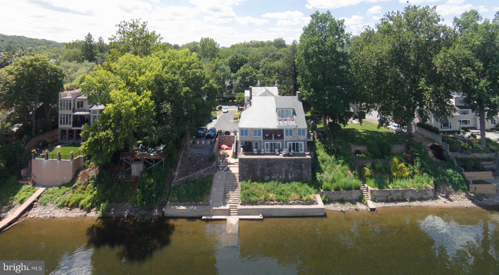 Riverside is a unique cluster of four condominiums being sold as one private property. The main riverfront condo is over 4,000 square feet on 2 floors with spectacular water views! Sitting on the long terrace or upstairs balcony one can view the New Hope-Lambertville Bridge, all of Lambertville, summer fireworks and dragon boat exercises. The condo below has the same spectacular river views and its own separate terraces. All units are three bedrooms and 2 – 4 baths. With the exception of one condo, all have fantastic riverfront views from the decks, terraces and windows. All Condos share river access by a ramp and concrete dock, as well as a lower level entertaining area. Currently Owner resides in main condo while 3 other units are fully rented and bring in $7,750 in rent every month. Riverside is ideal for a family compound, ownership with additional income or an opportunity to sell individual condos in the future. Located on coveted North Main Street and part of the New Hope/Solebury School District, Riverside is an investment opportunity that will never come along again and practically a guaranteed return on investment as the years past. The chance to buy four spacious river front homes for the price of one, is truly, the last of its kind.