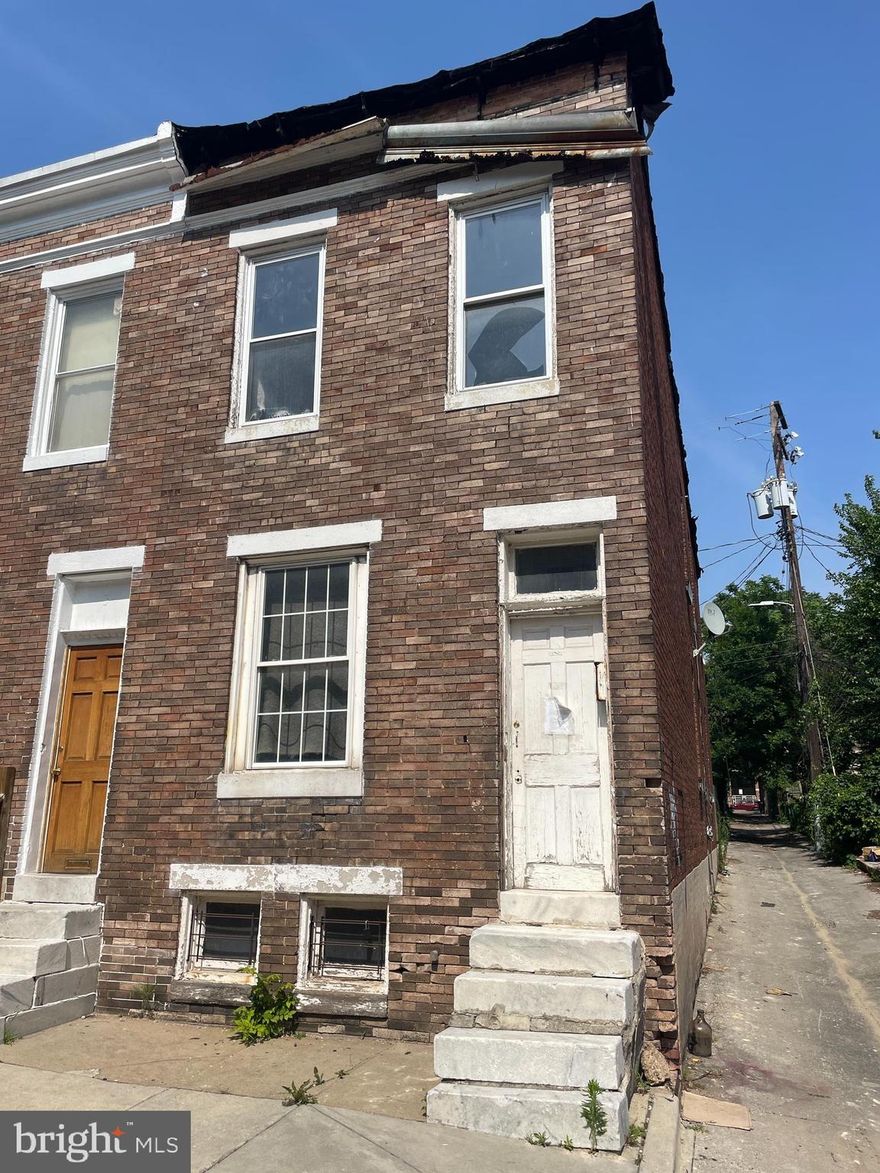 End-of-group rowhome located 2 blocks from Grace Medical Center. Overlooks Bon Secours Apartments. Large footprint. Needs renovation and roof replacement. There is updated ductwork in the basement and a forced-air furnace.  The 3 bedrooms upstairs include a pass-through. There is a 4th bedroom on 1st floor.