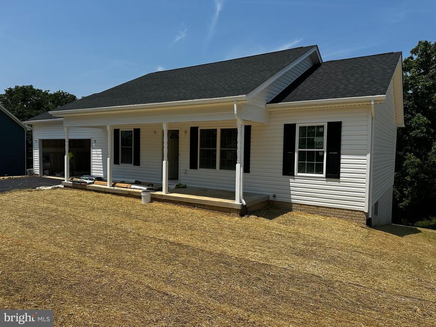 BACK ON THE MARKET, BUYER FINANCING FELL THROUGH!!! RADON TESTING COMPLETED, ALL GOOD. Welcome to your dream home, a stunning new construction nestled in a serene rural setting, set to be completed mid July. This charming ranch-style residence boasts an inviting open floor plan, perfect for modern living. Featuring 4 bedrooms and 3 bathrooms, the home offers an incredible value for the price. Step into the heart of the home, where the galley kitchen awaits, featuring upgraded countertops and stainless steel appliances, including a built-in microwave, electric oven/range, refrigerator, dishwasher, disposal and an ample pantry. The combination kitchen/dining/living area is ideal for entertaining. The large, enry level master suite includes walk in closet, a luxurious ceramic shower and double bowl vanity. The partially finished basement includes the 4th bedroom, third full bath and a spacious family room which opens to the back patio connecting you to the protected wooded area. An additional 500+ square feet of infinished basement area offers endless possibilities.  Enjoy the tranquility of your quarter acre wooded lot backing to protected green space which will never be built on, providing a peaceful retreat. Relax on your deck or patio, soaking in the natural beauty that surrounds you. With an attached garage and ample driveway space, parking is a breeze. This home is not just a place to live; it’s a lifestyle waiting to be embraced. Don’t miss the opportunity to make this exceptional property your own! NOTE THAT PHOTOS ARE OF PREVIOUS CONSTRUCTION, KITCHEN IS BEING REDESIGNED TO ADD A PENINSULA WITH OVERHANG FOR STOOLS.