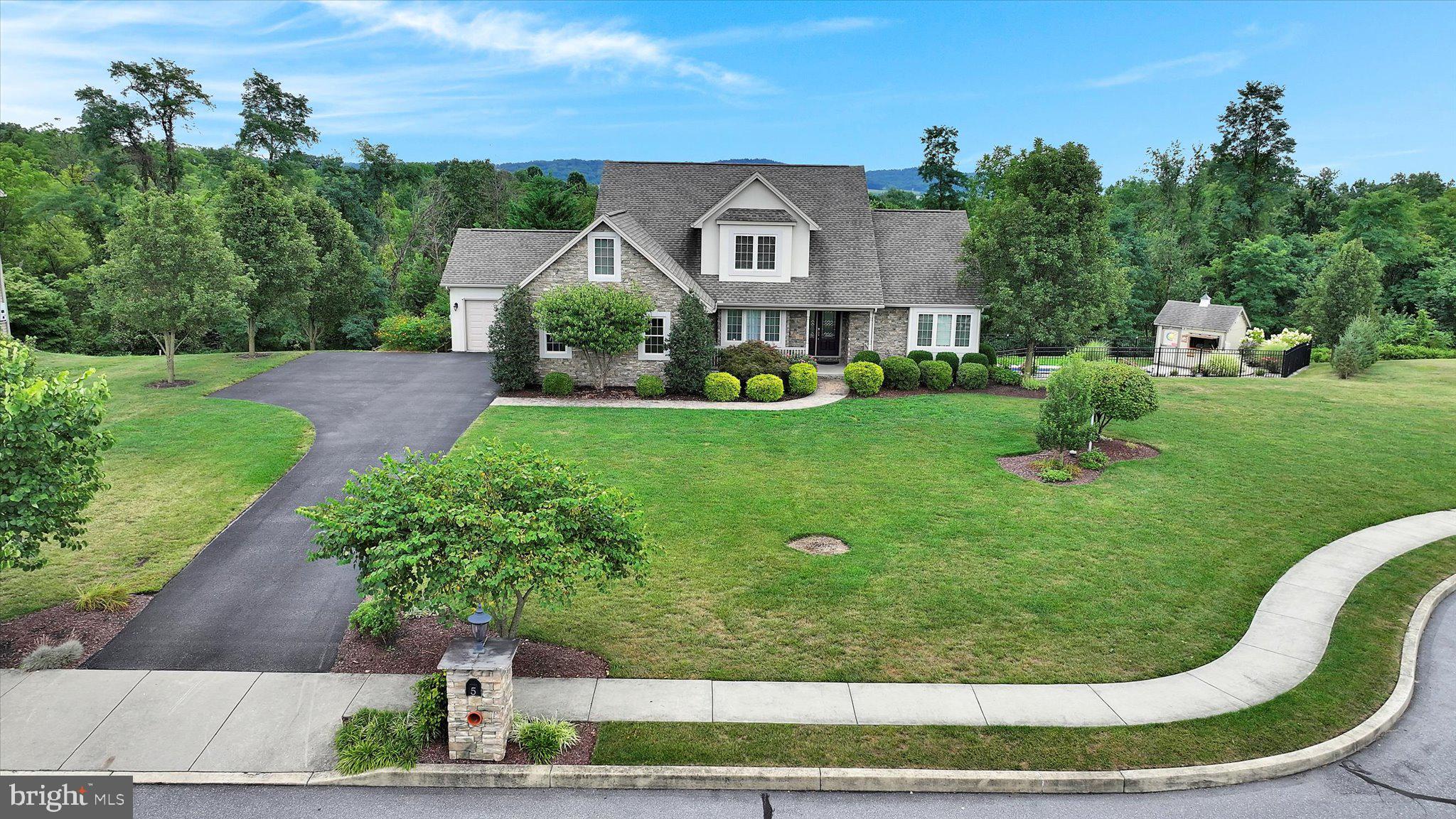 This stunning property is located on a spacious 1+ acre lot in a quiet cul-de-sac within the Lower Dauphin School District. The home features a first-floor primary bedroom with a vaulted ceiling and dual closets, along with a recently updated en-suite bathroom that includes a large tile walk-in shower and double vanity. The formal dining room boasts a tray ceiling, while the open and bright living room offers a 13-foot ceiling and a double-sided stone gas fireplace.
The kitchen is equipped with quartz countertops, a tile backsplash, a breakfast bar, and new appliances. Adjacent to the kitchen is a large screened-in deck that provides picturesque views. The second floor includes two additional bedrooms and a versatile bonus room suitable for music, gaming, or other activities.
The finished lower level includes a spacious recreation room, an extra bedroom, a full bathroom, and ample storage. A sliding door leads to a covered patio featuring a hot tub, a fishpond, and access to an inground heated saltwater pool. Additional highlights of the property include a 3-car split garage, a whole-house gas-powered generator, and a quiet private setting with wooded views.
(Note: Buyers are encouraged to verify square footage and room measurements independently.)