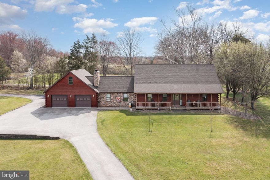 Your own piece of paradise awaits in this beautifully maintained log home situated on a 7.76 picturesque lot in Gettysburg School District. This 4 bedroom, 2 bath updated home features panoramic views of nature, a large two car garage with a bonus loft space, a detached workshop and shed, an above-ground pool, pasture, and so much more! The main floor features a welcoming two-story entryway, an open floor plan perfect for entertaining family and friends, separate living and dining rooms, an updated kitchen with granite countertops, a spacious family room with a cozy stone fireplace, two main floor bedrooms and a beautifully updated full bathroom with double sinks, soaking tub, and a gorgeous tile shower. The second floor features two additional bedrooms and a second updated bathroom. A new roof was just installed in September of 2024 offering peace of mind for years to come. Outdoors features a charming front porch perfect for taking in the views and a spacious backyard patio space with a firepit and propane grill hookup ready for outdoor enjoyment and entertaining. The oversized two car garage has a pellet stove and a/c window units for year-round comfort and offers ample space for your cars, tools, and hobbies, and features an overhead loft space with endless possibilities. The workshop and shed both have electricity and the shop has heat as well. Enjoy the best of both worlds; peaceful country setting yet just minutes from shops, dining, commuter routes 15 and 30, and centrally located close to both Gettysburg and New Oxford. A must-see home!