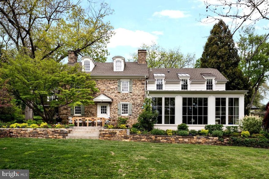 Steeped in Revolutionary-era history and set on over TWO acres, The John Fell House is one of the largest parcels in Doylestown Borough. This is a rare and remarkable property featuring a fully renovated and restored farmhouse with a permitted guest house, together totaling 7 bedrooms, 5.5 baths, and 5,500 square feet across both homes. Situated just moments from the heart of town, the property offers both walkable convenience and exceptional tranquility. 
As part of the Fell family’s 18th-century holdings, this property is deeply tied to the region’s colonial past—during the summer of 1778, General George Washington stayed in this very house and the Continental Army camped on the grounds as they advanced from Valley Forge. Today, the home seamlessly blends the original 18th-century heritage with refined modern living and creates a lasting link to American history.
The original section of the home preserves the earliest craftmanship, featuring a dramatic living room with a 9-foot walk-in fireplace, exposed beams, restored stonework, and wide-plank floors. A thoughtful addition, executed by Jarret Vaughn, harmoniously blends old and new. The main level is designed for everyday living and entertaining and includes a custom chef’s kitchen, sunlit living spaces, walk-in pantry, powder room, welcoming foyer with sweeping staircase, and a sunken living room with walls of windows overlooking the spectacular gardens and grounds. 
The home underwent a comprehensive renovation by Jarret Vaughn, with architecture by Period Architecture. New roof, new electrical, new plumbing, new everything - including a high-velocity central heating and cooling system with heat pumps. Smart home automation quietly controls lighting, blinds, and irrigation throughout, delivering modern ease without compromising the home’s historic soul.
The expanded layout includes 4 bedrooms and 3.5 bathrooms, including a beautifully appointed primary suite with a spacious walk-in closet and sumptuous bath. The third-floor bedroom provides a second en-suite, with the remaining two bedrooms sharing a beautifully designed his-and-hers bathroom.
The separate guest house is fully permitted as a second residence and offers exceptional flexibility, with a full kitchen, expansive living room, 3 spacious bedrooms, and 2 full bathrooms, ideal for extended family, guests, a private office, or rental income. 
A four-car garage with two new automatic openers offers significant covered parking and storage. Above it, a large bonus space with electricity is currently used as a gym, with the bones to finish into living space.
The captivating grounds are designed by award-winning Jerry Fritz of Linden Hill and feature lush, layered gardens with multiple patios for entertaining. An exceptionally rare in-borough heated pool with all-new equipment anchors the backyard, while a 400-year-old giant sycamore stands sentinel over the front of the property. The original 18th-century springhouse has been beautifully restored with a new floor beneath its historic roof, creating a magical open-air retreat within its ancient stone walls. At the rear of the fenced grounds, a private gate provides direct access to walk into downtown Doylestown, offering effortless reach to restaurants, shops, and the train station.
The John Fell House is a once-in-a-generation opportunity: documented colonial history, an iconic stone farmhouse, fully renovated for modern living, on one of the largest private parcels in the borough.