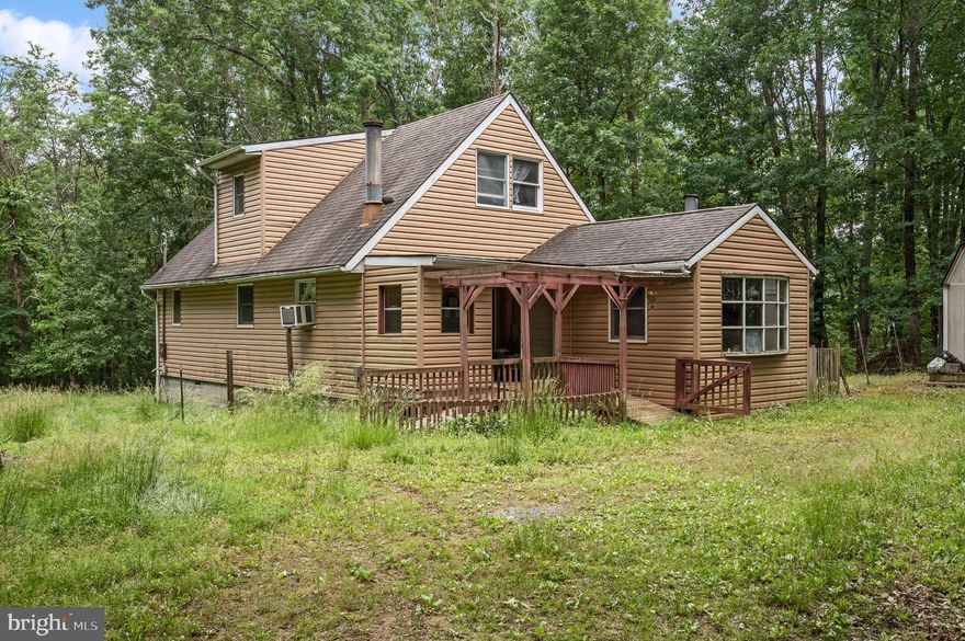 Escape all of the hustle and bustle to your private cottage in the woods. Situated on 4.14 acres of secluded land, this home really feels like an escape from it all! The rear yard is fenced, and the home is fully surrounded by mature trees, giving you privacy to enjoy entertaining from the back deck or simply relaxing on the front porch. There is a living room, eat-in kitchen, private office, laundry room, bedroom, and full bathroom on the main level. Upstairs, you will find two more bedrooms with vaulted ceilings and another full guest bathroom. All rooms in the house have ceiling fans. Like the rest of the house, the unfinished basement is waiting for your own personal touches. Come explore the possibilities of what could be!