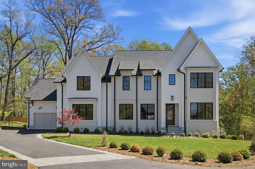 In a setting where nature enhances design, 2107 Elliott Avenue stands as Brush Arbor’s latest home, crafted with intention and grace in collaboration with Wellhouse & Co. Tucked into the desirable enclave of Franklin Park—known for its winding streets, oversized lots, and privacy—this 0.63-acre setting backs to protected green space, providing an extraordinary sense of seclusion in one of McLean’s most coveted pockets.

The white and grey paneled façade evokes a charming cottage sensibility, while the home itself is anything but quaint. A curated interior of over 7,550 thoughtfully composed square feet unfolds with six serene bedroom suites, five full baths, two elegant powder rooms, two fireplaces and attached 4-car garage, accessed by a private drive. The architecture is defined by balance and proportion, with intentionally layered finishes, designer-led materiality, and a natural palette that speaks fluently from one space to the next.
Upon entry, herringbone white oak floors welcome you, setting the tone for a home rooted in craftsmanship. The formal dining room—refined with an arched reeded accent niche—offers symmetry and rhythm that echo in the family room’s built-ins with reeded backing. Warmth is introduced through natural materials and custom finishes, bringing together every moment of the home in a quiet, confident harmony.

The kitchen, butler’s pantry, and family room are anchored by textures—wood, stone, and soft-toned plaster—all underscored by thoughtful design. A graceful arched opening into the butler's pantry provides both function and charm. Moments of delight are everywhere: from the symmetry of sightlines to the interplay of material finishes, each curated by Wellhouse & Co to feel distinct yet connected.
Intelligent infrastructure includes prewiring for a future elevator, screened porch with fireplace and expansive ceilings throughout. Oversized windows pour light into every corner, and even with its generous scale, this home retains a sense of intimacy and flow. Outdoors, the rear yard offers a fully private sanctuary with mature trees, green space, and generous room for future customization—gardens, sport court, or whatever life may inspire.

2107 Elliott Avenue is an expression of Brush Arbor’s highest work—designed in collaboration with Wellhouse & Co and featuring cabinetry by Studio 37. This is not a builder-grade new construction home; it is an architectural experience. A lifestyle of intentional luxury awaits—one where no detail is accidental, and every moment is elevated.

This is a home that deserves to be seen—and more importantly, felt.