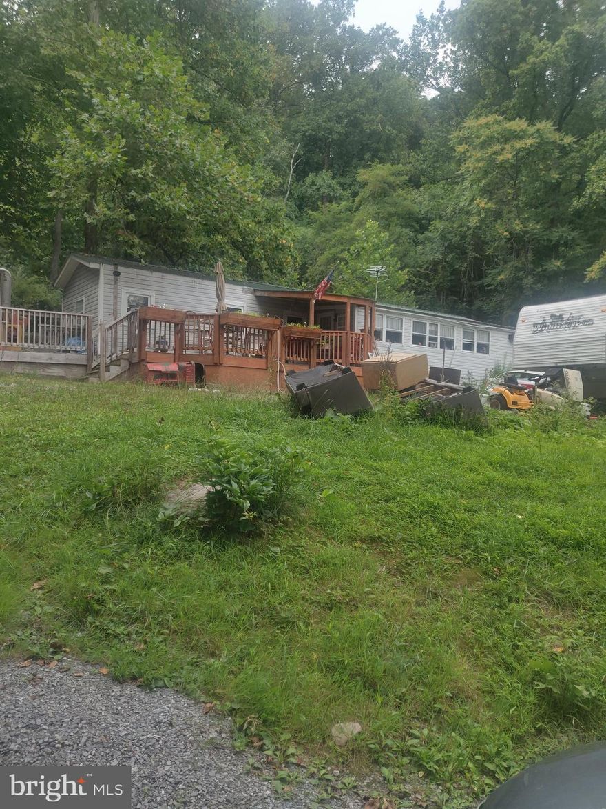 Just reduced! Property sold as-is. The mobile is a rehab. Camper in back conveys. Beautiful lot, mobile could be  rehabbed or removed and your dream home built. Junk and debris in the process of being removed.