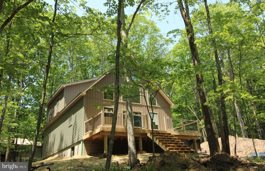 Welcome to BEAR PAW CHALET Located in  ALPINE LAKE RESORT! BRAND NEW BUILD... Almost Completed, Finishing up the Inside & Remainder of the Outside. Beautiful Wooded Setting close to the Lake. This home features a open floor plan, stainless steel appliances, LVT Flooring throughout. Primary Suite with attached full bath, Dual vanity, walk-in shower & walk-in closet. Great room features a Stone Gas Fireplace to RELAX by on those chilly evenings. Beautiful kitchen with granite counters. Front of the Chalet features Ceiling to floor windows to bring in the Natural BEAUTY around you. On the main level you will find the 2nd & 3rd bedrooms, laundry & utility room. Walkout to the Spacious deck to entertain and enjoy NATURE all around you! Enjoy Alpine Lake Amenities just a short distance away. The Amenities include: Restaurant/Lounge, Fitness Room, Indoor heated pool, game room, sandy beach, large fire-pit to sit and relax the days stresses away. Paved roads throughout, boat house with a concession hut, kayak/canoe & paddle boat rentals to paddle around the 125 Acre lake. Did I mention GREAT fishing, 24/7 SECURITY, Tennis/Basketball courts, 2 fenced-in dog parks by the boat house. If you are an OUTDOOR enthusiast there are plenty of hiking/biking trails to enjoy. Call today for more information about this Gorgeous property being Built...