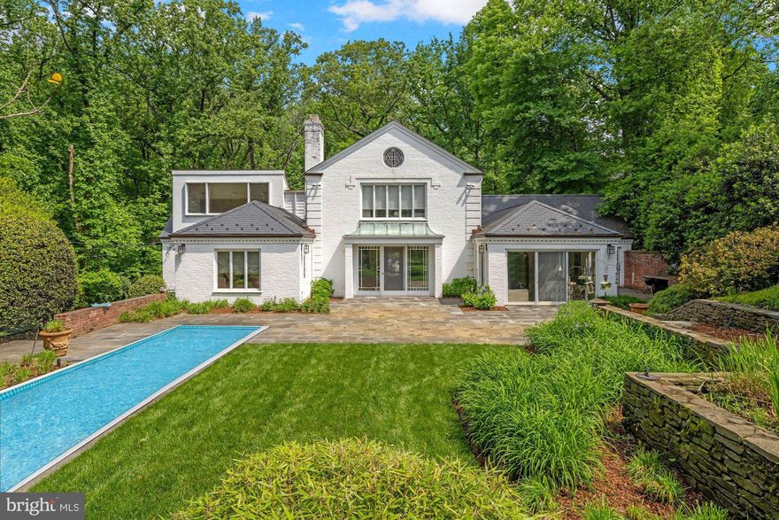 Fantastic new price and best value in 20016! Incredible opportunity on private, 0.93 acre lot in Wesley Heights! A setting like no other!  Nestled on a private road, abutting Battery Kemble Park, this sprawling 6,000 square foot home on  a 0.93 acre lot offers the ultimate private escape from the hustle and bustle of the city, while conveniently located just a stone’s throw from all that Washington DC has to offer! Highlights of this wonderful home include a formal living room with 9 foot ceilings, wood burning fireplace, and sliding glass doors looking out to the serene backyard and gardens, a grand dining room, a sunny family room wrapped in windows, and an over-sized kitchen with breakfast area and bonus room with full bath. The first level has two bedrooms and bathrooms including a spacious primary suite, and the second level has three additional bedrooms and two bathrooms. The lower level has ample space for a wonderful recreation room. Outside, take in the views of the park and the calming sounds of birds chirping while sitting by the pool or enjoying the beautiful gardens designed by renowned landscape architect, Oehme Von Sweden.  An expansive three car garage and private driveway complete the property. Showings by appointment only.