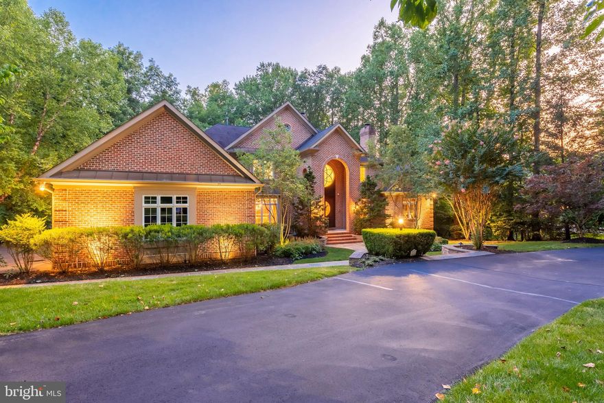 Custom built with exceptional detail and perfection, this architectural masterpiece is a rare find! Greeted by an open foyer with reception area, find spacious formals including dining room with architectural tray ceiling, cove lighting and butlers pantry and living room with 2-sided gas fireplace to gorgeous custom library with cherry paneling, coffered ceilings and private balcony! Amazing 2-story great room featured domed palladian bay windows, custom built-ins, and uplit display ledge w/ hand-forged wrought iron railings.  Entertain from gourmet kitchen finely appointed with   2x Dacor ranges, dual Bosch dishwashers, 2X Subzero refrigerators, granite counters and custom cabinets by Classic Kitchens! Step outside to screened in porch and tiered deck amongst private yard with fairway views! Main level owner's suite with 2x walk-in closets, tray ceilings, custom cove and reading lighting, oversized sitting room with 3 way fireplace and access to private porch! Luxe attached bath with  jetted walk-in shower, separate granite vanities, air jetted tub and pitched cathedral ceiling with custom lighting! Elevator access to upper bedrooms, each with attached baths, WIC, and architectural features unique to each space!  Finished lower level rec room seating area, entertaining room, movie theater w/ tiered seating and stage, home gym & cigar room!  So many additional features, upgrades & custom detail... this home is ready to enjoy & impress