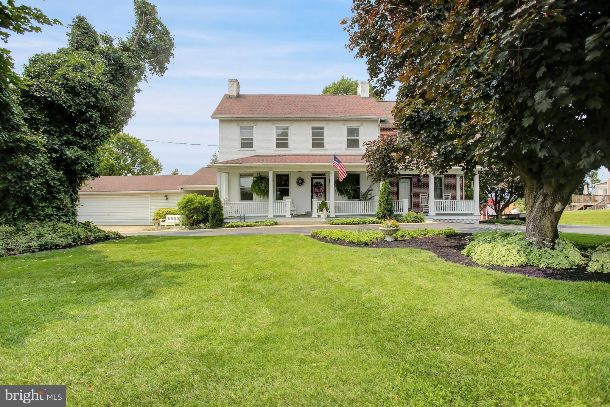 Step into history with this captivating 1854 farmhouse, nestled on a picturesque .73 acre lot backing to sprawling farmland and framed by stunning mountain views. This 3-bedroom, 1.5-bath home exudes character with three brick fireplaces, original pine floors throughout (including under the carpet), and a spacious and relaxing front porch that spans both the farmhouse and an attached, modern 1-bedroom, 1.5-bath, two-story residence—currently rented, offering income potential or a perfect space for additional family to live close by. Civil War-era artifacts discovered in the yard add a unique historical allure to this property. The farmhouse features a detached summer kitchen, a true gem with a stone fireplace, loft, and cellar below, ideal for creative uses like a studio or workshop. The main home is connected by a breezeway to an oversized two-car garage, equipped with a working hot/cold water sink and its own hot water tank, and two suspended heaters for year-round comfort. A dedicated laundry room adds convenience. Blending historic charm with modern functionality, this property offers endless possibilities—whether you seek a serene retreat, a home with rental income, or a connection to the past. Don’t miss this rare opportunity to own a piece of history with breathtaking views and versatile living options!