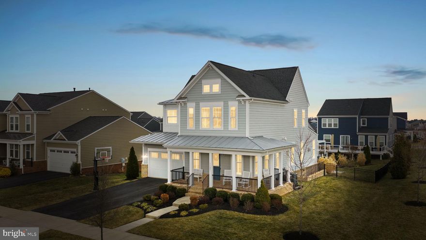 PRICE IMPROVEMENT!

Welcome to 1125 Themis Street in the sought-after Meadowbrook Farm community by Van Metre! This stunning Grandin II model offers 5 bedrooms, 4.5 bathrooms, and a 2-car garage on a spacious .32-acre corner lot with a fully fenced rear yard and charming wraparound porch — the perfect place to enjoy your morning coffee or unwind in the evenings.

Designed with an open and functional floor plan, this home features luxury vinyl plank flooring throughout, a cozy gas fireplace with a stunning wood mantel, and a gourmet kitchen with an extra-large island ideal for entertaining. A dedicated office on the main living level provides the perfect space for working from home or a quiet study area. Plantation shutters add timeless elegance and style throughout the home. The mud room off the garage adds everyday convenience, and the garage is equipped with an electric car charger.

Upstairs, you’ll find generously sized bedrooms and well-appointed baths designed for comfort and functionality, along with the convenience of a laundry room located on the bedroom level. The spacious primary suite serves as a true retreat, featuring two customized walk-in closets and an additional large walk-in linen closet for exceptional storage.

The fully finished basement expands your living space with a large recreation room, dry bar, legal bedroom, full bathroom, and two separate storage areas, offering flexibility for guests, multigenerational living, or additional workspace.

Step outside to your private backyard retreat complete with a deck featuring an outdoor TV and covered seating area — ideal for relaxing evenings or hosting year-round gatherings.

Meadowbrook Farm residents enjoy access to a community pool, clubhouse, tot lot, and walking paths. Conveniently located just minutes from historic downtown Leesburg, commuter routes, the Leesburg Outlets, wineries, schools, and shopping, this home perfectly combines luxury, location, and lifestyle.