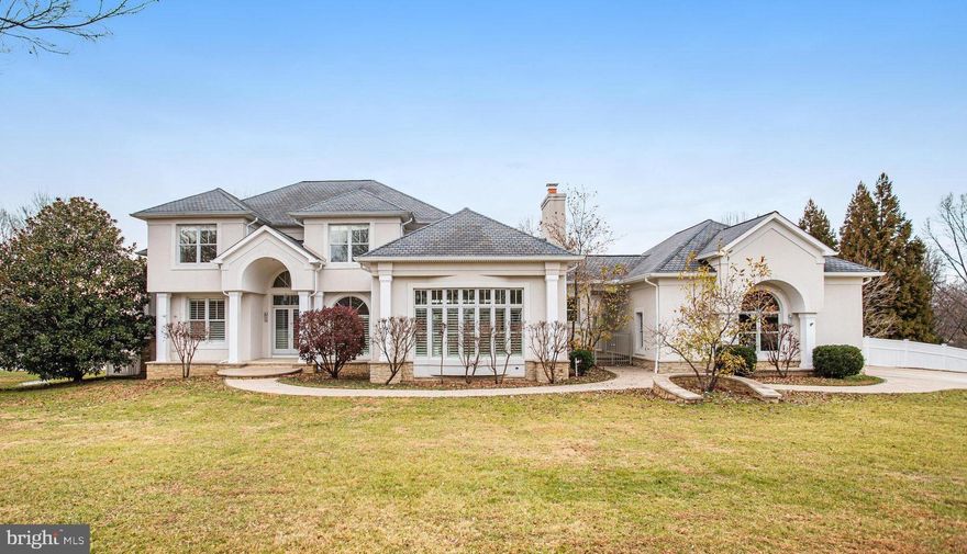 A rare opportunity to experience refined living in one of the most serene settings, this beautifully crafted home blends architectural drama with thoughtful design and exceptional comfort. The moment you enter, soaring cathedral ceilings and striking Italian marble flooring create an immediate sense of luxury, drawing natural light across the home’s elegant living spaces. Every room has been designed with both beauty and functionality in mind—from the formal dining room ideal for memorable dinners and celebrations, to the inviting main living areas that transition effortlessly between relaxed everyday living and sophisticated entertaining. The kitchen is truly the heart of the home—expansive, open, and filled with natural light from endless windows. A large central island anchors the space, offering exceptional room for cooking, gathering, and hosting. Its seamless connection to the surrounding living spaces makes it perfect for both intimate evenings and large gatherings. The main-level primary suite provides outstanding convenience and comfort, ideal for those seeking true ground-floor living. With additional private spaces available throughout the home, the layout easily accommodates multi-generational living or extended-stay guests. The expansive basement further enhances the home’s versatility, featuring a dedicated home theater room and a kitchenette—perfect for movie nights, added living quarters, or extended entertainment space. Additional flexible areas offer endless possibilities for recreation, a studio, or customized use. Outdoor living transforms this residence into a personal retreat. A private in-ground pool anchors the backyard, offering a serene place to unwind, enjoy warm weather, or entertain outdoors. The generous lot enhances privacy and tranquility, creating an atmosphere that feels worlds away yet remains close to everyday conveniences. Blending timeless appeal with exceptional livability, this home delivers elegance, comfort, and remarkable flexibility—a rare chance to enjoy a lifestyle defined by both luxury and ease.