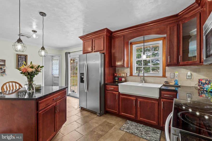 Welcome home to this attractive brick rancher offering comfort, functionality, and great outdoor space! The main level features a bright kitchen with durable tile flooring, cherry cabinets, granite countertops, and a convenient island—perfect for meal prep and gathering. Relax in the cozy living area highlighted by a fireplace (conveys as-is), with the option to add a ventless insert for enhanced efficiency and convenience. All three bedrooms are located on the main level, along with two full baths—one serving as the primary bath and the second conveniently located in the mudroom.

The finished basement adds valuable living space, including a bonus room, additional storage, and LVP flooring throughout, with newly installed carpet (Spring). The basement also includes baseboard heating and a waterproofing system with a transferable warranty for added peace of mind.

Step outside to enjoy the new deck overlooking a fully fenced backyard (chain-link), complete with a large concrete pad and storage shed—ideal for entertaining or relaxing.

The home features durable brick with asphalt shingles approximately 17 years old and recently replaced front gutters. Conveniently located with a school behind the home.

Don’t miss this opportunity to own a move-in ready home with plenty of space inside and out! ***BACK ON THE MARKET AT NO FAULT OF THE SELLER...BUYER FINANCING FELL THROUGH***