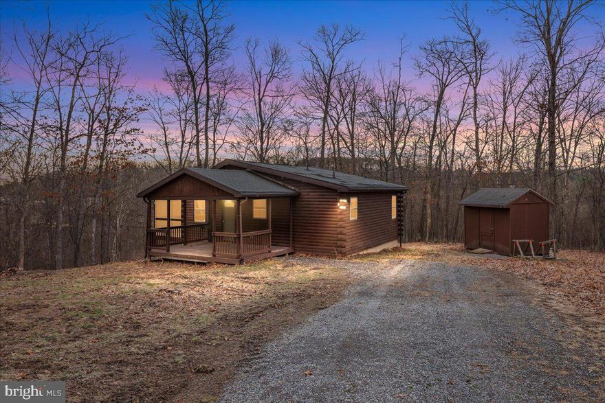 Tucked away on just over 2 private wooded acres in Hedgesville, this charming cabin-style retreat offers the perfect blend of comfort, nature, and modern convenience. Surrounded by mature trees, the property features a large screened-in porch where you can relax and enjoy peaceful wooded views year-round.<br><br>

Inside, the home offers an open living and dining area with vaulted ceilings, warm wood accents, and plenty of natural light. The kitchen features beautiful natural wood cabinetry, ample counter space, and a functional layout ideal for everyday living.<br><br>

The home is equipped with a GE Profile all-in-one combo washer and dryer, maximizing convenience while saving space. Additional upgrades include a newer roof with gutter guards and a water softener and filtration system by Sunset Water Company for improved water quality.<br><br>

Outdoor living truly shines with a spacious screened porch overlooking the wooded property, plus a cozy fire pit area perfect for evenings under the stars. The covered front porch provides another inviting space to relax and take in the peaceful surroundings.<br><br>

Whether you're looking for a full-time residence, weekend getaway, or investment opportunity, this private mountain retreat offers comfort, character, and room to enjoy nature just minutes from the amenities of the Eastern Panhandle.