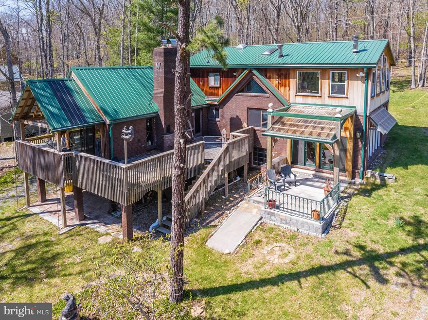 Spacious five-bedroom home full of character and potential, set on a breathtaking 100' of split lakefront. This home offers plenty of large windows to enjoy the outside during any season. Boasting hardwood floors, cathedral ceilings, and a fireplace. The setting is truly the star—enjoy sweeping water views, serene surroundings, and direct access to the lake. Property includes a highly desirable Type A dock permit, perfect for boating enthusiasts and making the most of lake life. A rare chance to create your dream retreat in an unbeatable waterfront location.