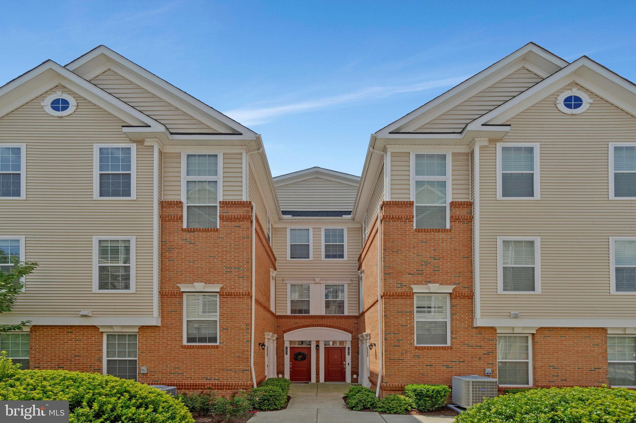 Welcome home to the Ridges at Loudoun Valley! With a prime location just three miles from the Ashburn Metro Station, this luxurious two-level townhome-style condo offers the perfect blend of comfort and convenience. On the main level you’ll discover an open floorplan designed for both everyday living and effortless entertaining with soaring ceilings, sleek hardwood floors, and recessed lighting. The modern gourmet kitchen features floor-to-ceiling cabinetry, stainless steel appliances, granite countertops, a classic subway tile backsplash, and an oversized island with breakfast bar—ideal for casual meals or hosting friends. Just beyond, the light-filled morning room is wrapped in wall-to-wall windows, making it the perfect setting for intimate meals or lively dinner parties. Upstairs, you’ll find two generously sized bedrooms, each with its own private en suite bathroom and exceptionally large walk-in closet with custom shelving. The spacious primary bath includes a dual-sink vanity and a step-in shower, while the second bathroom is equally tasteful with a wide vanity, modern fixtures, and abundant storage. For added convenience, laundry is located on the bedroom level. From the main level, step out onto your private, covered balcony to enjoy your morning coffee or take in the peaceful, scenic views. With a one-car garage, a full driveway, a dedicated storage room, and ample guest parking, this home offers abundant space for both storage and parking. Residents enjoy access to a wealth of community amenities, including three outdoor pools, on-site fitness centers, basketball, tennis, and pickleball courts, playgrounds, and multiple clubhouses with event spaces. Ideally situated in the heart of Ashburn, you’ll be just minutes to Harris Teeter, Aldi, Brambleton Town Center, One Loudoun, Leesburg Premium Outlets, Dulles South Recreation Center, Hanson Regional Park, Broad Run Trail, and Dulles Airport. Only three miles to the Ashburn Metrorail Station, with quick access to the Loudoun County Parkway, Dulles Greenway, Route 50, and I-495 for easy commuting and traveling around Northern Virginia. Schedule your private tour today and experience everything this gorgeous home and vibrant community have to offer!