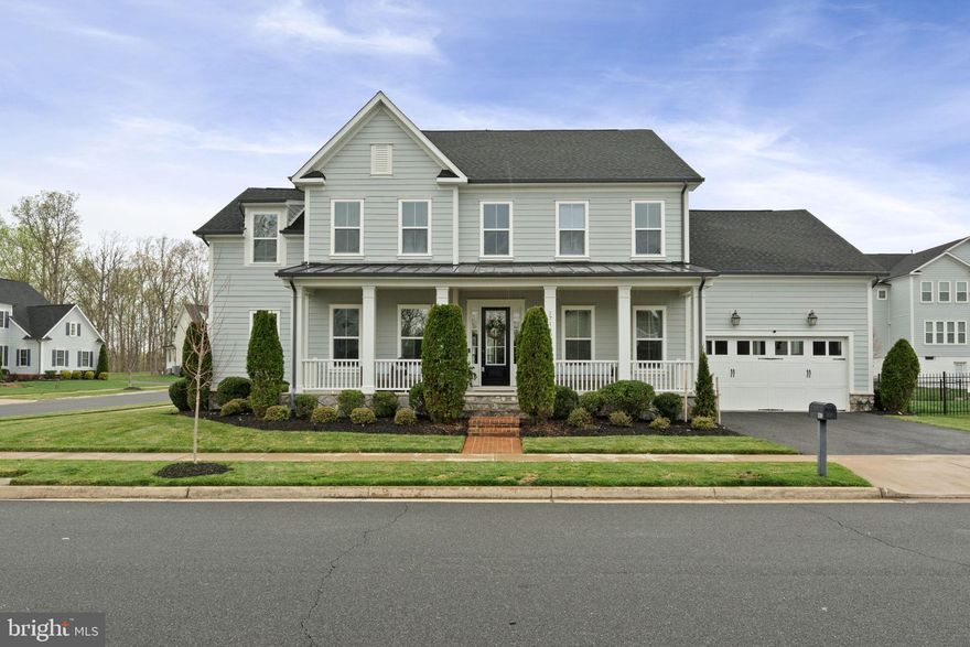 Welcome to this stunning NV-built Portsmouth floor plan in the sought-after Potomac Shores community, offering 6,809+ sq. ft. of luxurious living space on a premium corner lot with a three-car garage, including a tandem space. This home boasts an impressive six bedrooms and six full baths, five bedrooms upstairs, each featuring an attached bath, and a sixth bedroom with an egress window in the finished basement. The grand entrance greets you with formal living and dining spaces and a curved staircase leading to the upper level. A private home office is tucked away on the main level, conveniently located on the quiet side of the home with a half bath nearby. The heart of the home features a light-filled family room with a coffered ceiling and a gas fireplace. The chef’s dream kitchen features a massive center island with new stunning quartz counters,a gas stove with a pot filler, stainless steel appliances, and a pass-through serving area with a sink leading to the dining room—perfect for entertaining. The finished basement offers an expansive wrap-around bar, a flex room ideal for a gym or media space, and a large storage room. Upstairs, the primary suite is a retreat, complete with a tray ceiling, a spa-like bath with a soaking tub, a free-standing shower, double vanities, and a large walk-in closet. Each of the four additional bedrooms has an attached bath, and the walk-in laundry room is equipped with a laundry sink and under-counter cabinets. The home has a complete whole-house suppression system, a dual-zoned HVAC system, and luxurious finishes at every turn. More than just a home, this is resort-style living at its finest. It has access to Northern Virginia’s only public Jack Nicklaus Golf Course, The Shores Club, with resort-style amenities and a vibrant social scene with clubs, classes, meetups, and community events. With the future Potomac Shores VRE Head House under construction and the upcoming town center, Potomac Shores is a place where future conveniences meet luxury. Don’t miss your chance to experience this one-of-a-kind home—schedule your tour today!