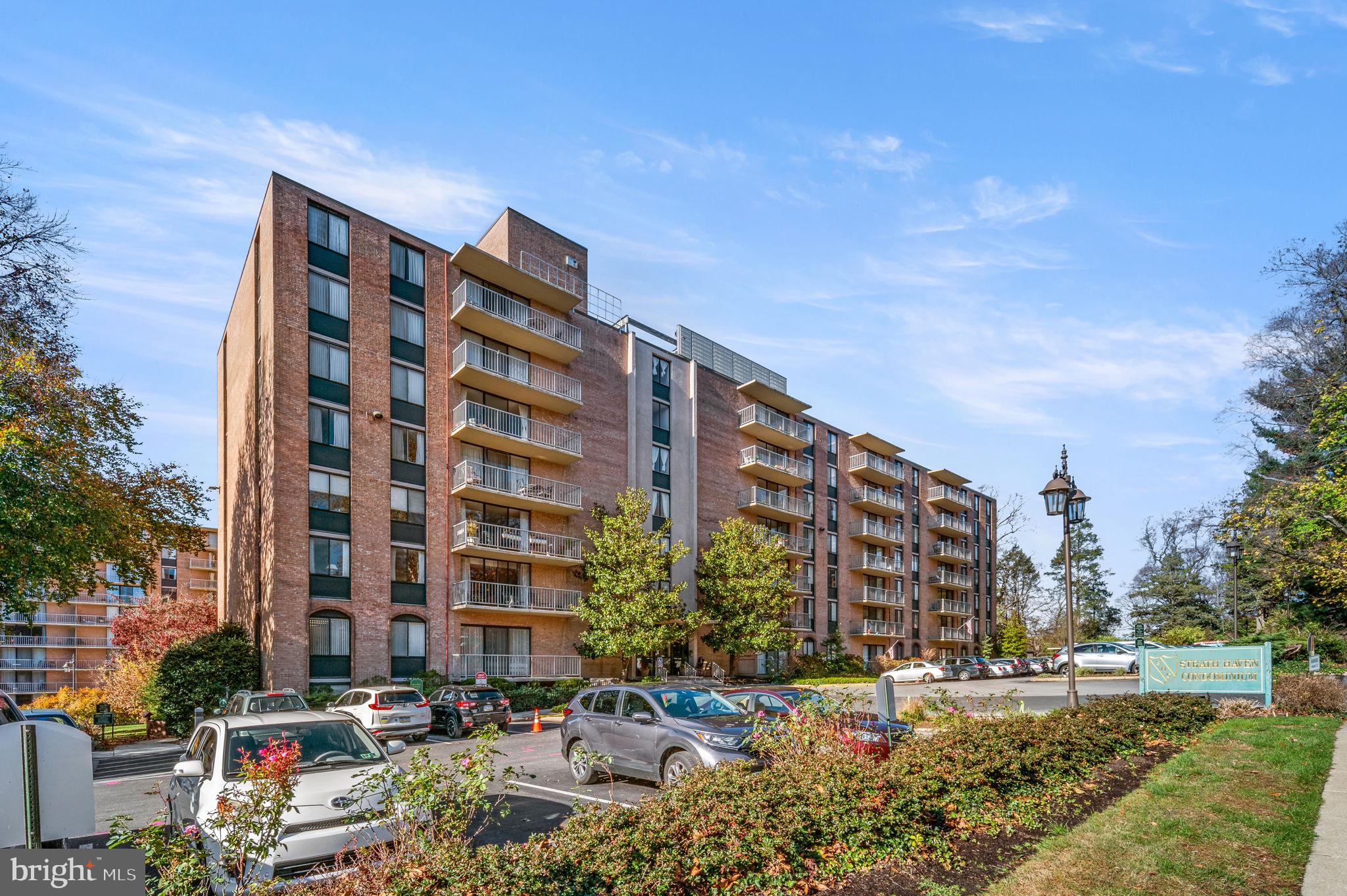 Welcome to Unit #1119 at the highly sought-after Strath Haven Condominium—a beautifully maintained, light-filled corner unit offering 2 bedrooms, 2 full bathrooms, and a generous 1,180 square feet of living space. The condo includes a covered carport which is a sought after amenity. Similar carports have sold for over $12,000. This rarely available end unit boasts an ideal east and south-facing orientation, filling the home with natural sunlight throughout the day. Enjoy your morning coffee or unwind in the evening on the large private balcony overlooking charming Harvard Avenue. Unlike standard two-bedroom units in the building (typically 1,050 sq ft), this expanded floor plan features a spacious open-concept living and dining area, ideal for entertaining or relaxing. A wall of plate glass windows and a sliding glass door invite you out to the balcony and provide a seamless indoor-outdoor connection. The galley kitchen is smartly designed with ample cabinetry for storage and organization. A pass-through window to the living room creates a sense of openness and allows even more light to filter into the space. The generously sized primary bedroom is bathed in southern light and offers serene views of a stately copper beech tree. The bedroom also features an updated en suite bathroom with a stall shower and abundant closet space. The second bedroom is equally spacious with a large closet and direct access to the second full bath, which includes a shower/tub combination—perfect for guests or flexible use as a home office or den. A laundry closet with a stackable washer and dryer, along with additional storage space, adds to the unit’s practicality. Strath Haven is a Gold Star Community, recognized by the Community Associations Institute for excellence in management and maintenance. Its prime location offers easy access to Swarthmore College, the Scott Arboretum, charming local shops, the regional train station, and Crum Woods walking trails. Your monthly condo fee covers virtually everything—electricity, gas, water, sewer, heating, air conditioning, building and grounds maintenance, an outdoor pool, library, meeting and hobby rooms, and even a community van for local shopping trips. The only additional cost is cable/internet. Don’t miss this rare opportunity to own a spacious, sunlit corner unit with balcony views of Harvard Avenue—schedule your private showing today!
