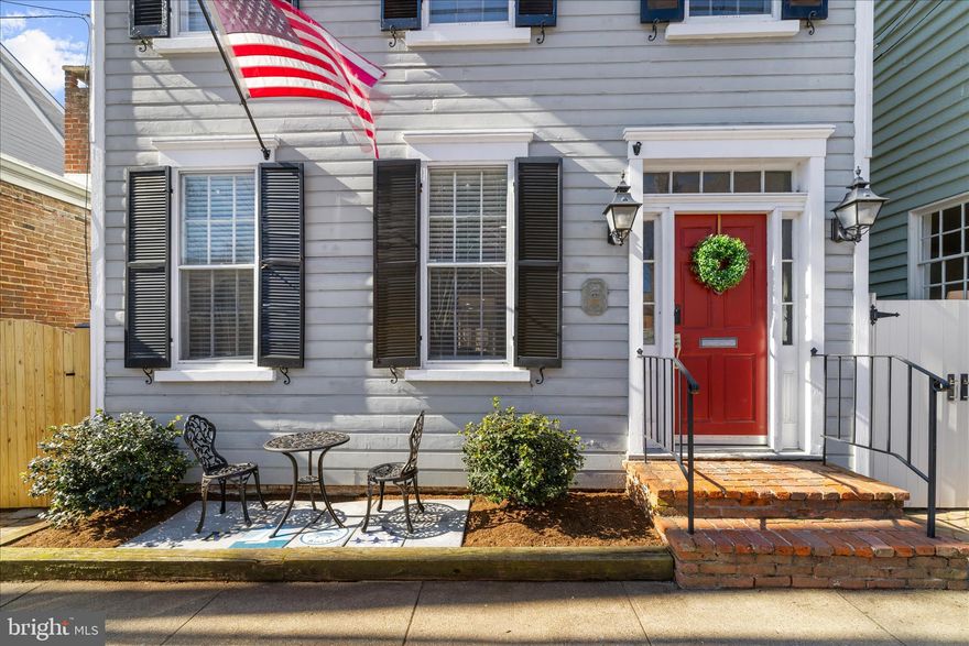 An outstanding opportunity to enjoy the very best of Historic Annapolis living.  Located on one of the most charming and desirable streets in Historic Annapolis, this beautifully updated  home offers a rare combination of timeless character, thoughtful improvements, and an exceptional sense of space and privacy. With no direct neighbors in front or behind, the home enjoys an open, airy setting that is hard to find in such a prime downtown location.
Inside, historic details are thoughtfully complemented by modern updates throughout. The welcoming living room features a gas fireplace and sets the tone for the home’s warm and inviting feel. The kitchen and dining area flow effortlessly into a comfortable family room with a built-in bar—ideal for both everyday living and entertaining. 
Upstairs, three well-appointed bedrooms provide peaceful retreats, including a spacious primary suite with a private foyer, en suite bath, and access to a deck overlooking the backyard. From here, enjoy views of the Maryland State Capitol dome—an iconic Annapolis backdrop, especially when illuminated in the evening. A fully floored attic, accessible from the primary bedroom, offers generous storage across the entire footprint.
The outdoor space is equally impressive, featuring an expanded brick patio, new fencing, and landscaping that create a private and inviting setting for relaxing or entertaining. The roof has been replaced within the past six years, adding to the home’s overall upkeep and value.
Ideally located just steps from the waterfront, Ego Alley, the U.S. Naval Academy, Maryland Avenue, and Main Street, this home offers the very best of Annapolis living—historic charm, modern comfort, and an unbeatable walkable lifestyle. Its proximity to the City Dock Resiliency Project further enhances long-term appeal, reflecting the City’s investment in preserving and improving this treasured waterfront area for years to come.
