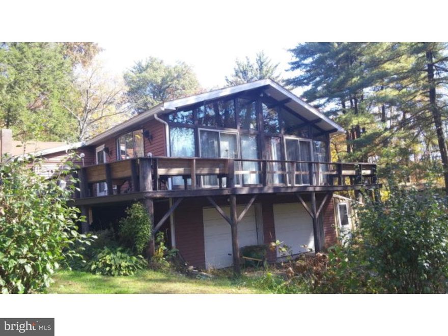 A wall of windows supply natural light in this home surrounded by trees. Patio doors in the family room and master bedroom lead to the deck where you can relax and enjoy the outdoors. Bathroom off master bedroom. First floor laundry for convenience. Keep warm this winter with the wood stove in the living room. The peninsula in the kitchen has storage on both sides and seating for 6. Exterior features include a shed and chicken house. A small bridge over the pond gives the yard character. Plenty of extra storage in the attic.