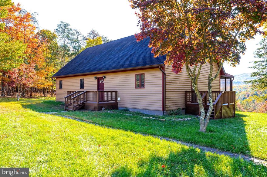 Seller is taking “backups.!” Ask your agent for a showing today! You can see for miles from the deck of this spacious colonial-style home, featuring a first-floor master suite and 4 bedrooms and 2 1/2 bathrooms in total, all nestled on 5 acres of gorgeous West Virginia land just a mile or two from Capon Springs Resort and George Washington National Forest. As you approach, you are greeted by a split rail fence and stately stone pillars that flank the driveway entrance. There's plenty of parking for guests, and a slate walkway that leads to the front porch, perfect for a couple of rocking chairs. Just inside you'll find a large, bright foyer with hardwood floors and a large guest closet.  On your left is a large powder room featuring a 4 ft single bowl vanity with an updated shaker-style base cabinet and porcelain tile floors.  Beyond this is the spacious (15 x 20) living room with hardwood floors and chair rail.  This room features a ceiling fan w/light fixture and cozy airtight woodstove with a native stone wall behind and a raised, slate hearth beneath. Two patio doors lead to the huge (10 x 34) rear deck. Close by you'll find the gourmet kitchen, outfitted with hardwood floors, raised panel cherry cabinetry, granite counters, updated stainless appliances and newly refinished hardwood floors - all showcased under recessed and track lighting. The kitchen is open to the large (14 x 15) dining room with hardwood floors and a bronze Tiffany-style fixture. Patio doors open to the screened porch. Pine stairs lead you upstairs to the second-floor hallway with refinished hardwoods and three generously sized bedrooms, each with ceiling fans, ample closet space and a large window to take in the view. The hall bath features a 5 ft vanity, a 5 ft tub/shower and porcelain tile floors. Finally, you have a nice study/office with bamboo floors. Outside you have the lovely screened in porch off of the dining room. Enjoy morning coffee or an outdoor meal without the "no-see-ums"! A screened door leads to the large deck. This is the perfect space for hosting your BBQ or enjoying the sunshine. A set of double stairs lead to the lush, cleared yard and the million-dollar view beyond. The property includes a large 10 x 18 Amish-built gardening shed, perfect storage for your yard tools and maybe an ATV or two. And there's another shed to store your firewood - or make it a chicken coop for fresh eggs, if desired. This home has so much to offer, and just a short (40 min) drive to Winchester, VA. Call for your showing today!