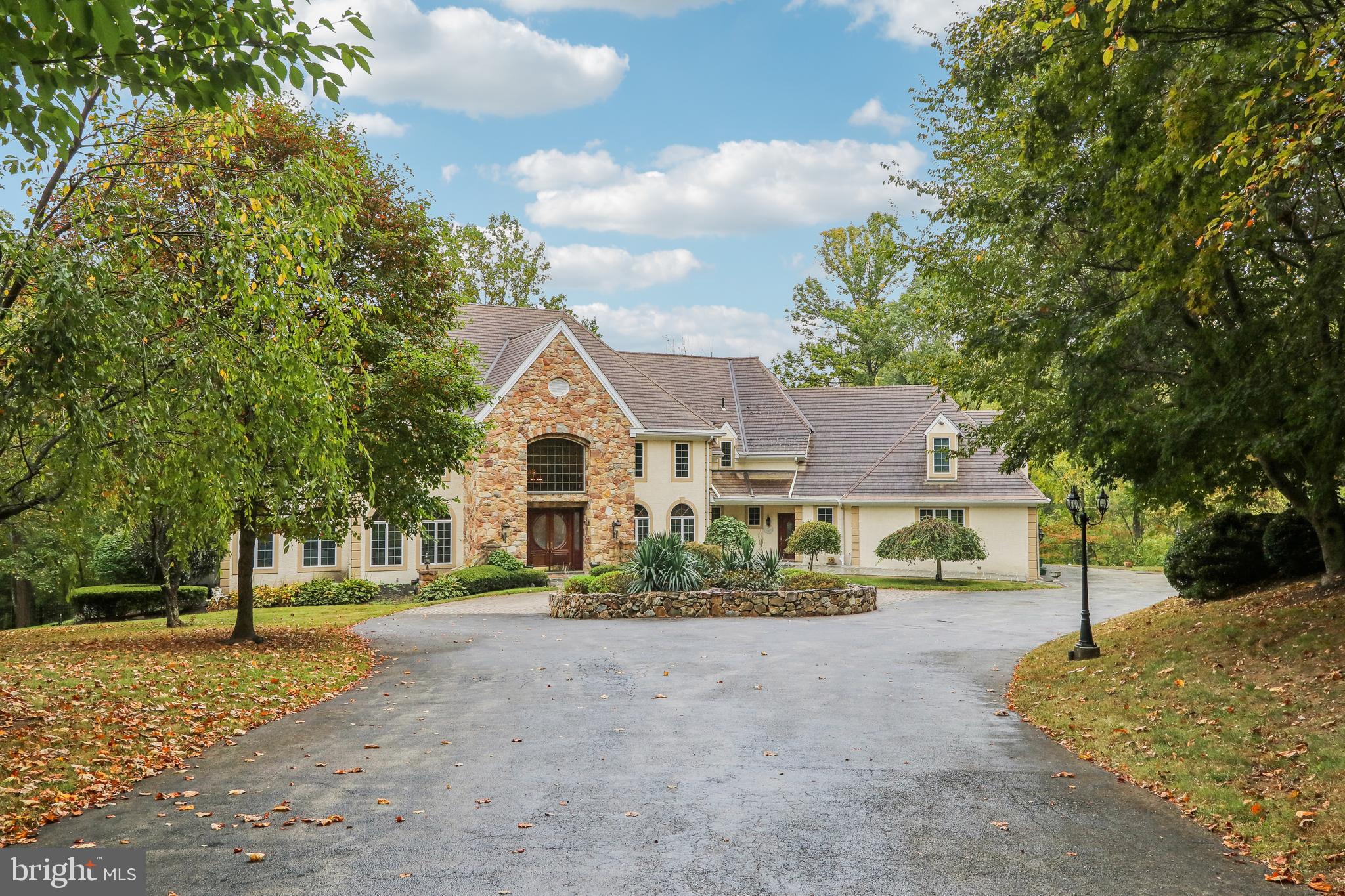 Welcome home to 6007 Goshen Rd- a custom built, beautiful property on a 5+ acre lot in the heart of Radnor Hunt and top rated Great Valley School District. This 5 bedroom, 6.1 bathroom home exudes elegance from the second you enter through the gated driveway. Offering hardwood flooring throughout the first and second levels; 10 ft ceilings on the first floor; a grand foyer with marble flooring imported from Greece; an expansive formal living room with gas fireplace and walls of windows for natural sunlight; and a formal dining room with swinging door to a butler’s pantry offering tons of counter and cabinet space and an additional fridge. Off of these areas is a gourmet kitchen with commercial grade appliances and island seating; a breakfast area for casual dining; a family room with floor to ceiling stone fireplace and built-in entertainment center; sitting area with built-in bar; and a formal office with a built-in bookcase wall. This floor is completed with 2 powder rooms and a mudroom area with back staircase. The second floor offers a magnificent primary suite with sitting area with gas fireplace, huge walk-in closet with organizational system, and a luxurious bathroom with dual vanities, stall shower, and soaking tub. Two of the bedrooms are ensuite offering private bathrooms while other two share a bathroom- all 4 bedrooms have walk-in closets. The lower walk-out level is also finished and offers tons of extra living space in addition to a built-in porch with hot tub for year round usage and a bonus room that could be used as a bedroom since there is a closet and attached bathroom. All of this plus a 3 car attached garage; flat rear yard that is completely private; and an unbelievable outdoor living space with a flagstone deck off the entire back of the house and a flagstone patio underneath with slow cooker grill. This property is in a fantastic location- close to all major roadways for an easy commute to Philadelphia, Wilmington, and NYC; minutes to Malvern Borough, downtown Wayne, and the dining of Ellis Preserve; and central to come of the best private schools in the country- Episcopal Academy, Malvern Prep, the Agnes Irwin School, and the Haverford School. Call today to see this magnificent property; it truly is one-of-a-kind!