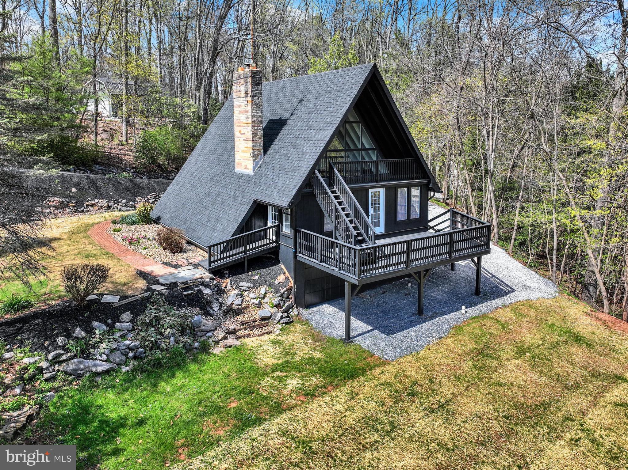 Nestled on 2.67 acres at the end of a quiet dead-end road, this charming 3-bedroom A-frame home overlooks a peaceful creek, offering the perfect blend of comfort and seclusion. Featuring an open floor plan, 2nd floor loft and a cozy stone fireplace, the interior flows effortlessly, while the finished basement provides extra living space with direct access to the attached garage. the windows allow plenty of natural light. A detached garage adds even more storage or workshop potential. Step outside to a spacious two-story deck—ideal for enjoying the surrounding nature and entertaining guests in style.