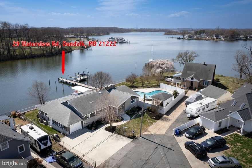 This is a unique opportunity to own waterfront with a pool in an extremely convenient location. This property has not traded since 1955. Here's what is now available after these 70 years:

Pull into your three car driveway, and if you want, park in your garage. Walk through your manicured front yard to the front door, throw your jacket in the closet and walk to your newly renovated kitchen. From the kitchen you will survey your 150+' waterfront, just over your in ground pool with with a huge space to entertain.  Walk out to your pier with space for 5 boats, one 10,000# lift. If you would like, hang out by the water while you grill in the shade. When you are tired, come relax inside with great views of the water through all of the windows. Really tired from boating all day? It's time to crash in the main bedroom, where you have your own newly renovated bathroom. The rest of the space has another three bedrooms and another freshly renovated hallway bathroom. There is a basement, which connects with the garage. 

Come take a look. Opportunities like this don't come along often.