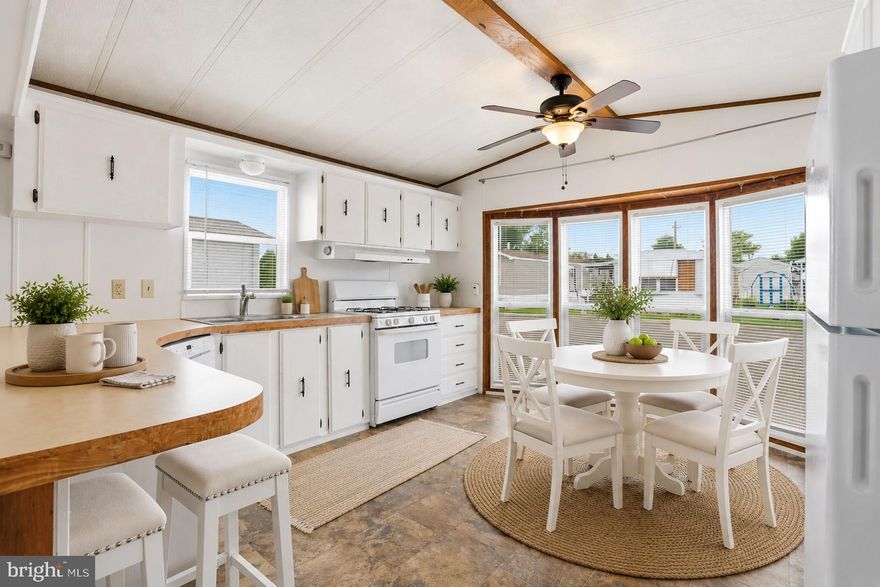 Welcome to "the land of simple living" in Winterset Farms Manufactured Home Community! Lovely covered deck greets you as you enter this spacious home with a white, bright, front kitchen surrounded by lots of windows for so much natural light! Refrigerator is included.  Spacious living room, 2 bedrooms and a full bath and also a convenient laundry area (washer and dryer are included). House has been freshly painted throughout.  Shed is also included. An American Home Shield Home Warranty is also included! Come see! Super cute, light, bright home!
(Manufactured home loans are acceptable but homes not eligible for a mortgage since it is a lot lease and you do not own the land.)