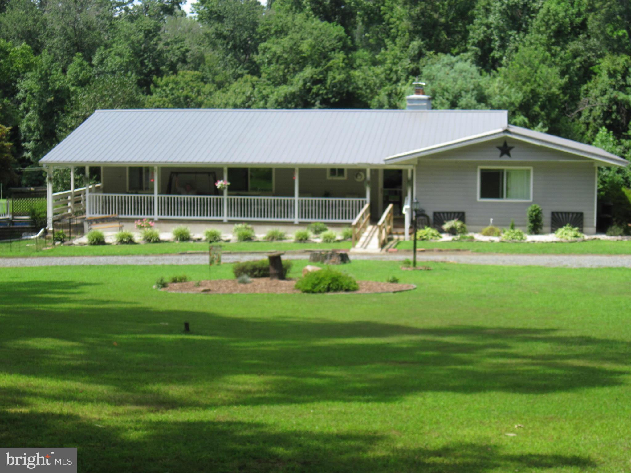 HUGE PRICE REDUCTION! Wooded & Serene are just a couple words to describe this almost 7 acre home. Compare before & after exterior pics for an amazing makeover. LL could easily be an in-law suite, or just a family area. There is a great room, kitchenette, full bath, two bedrooms and a gas fireplace. Has a separate entrance from rear yard and a spiral staircase to main level.