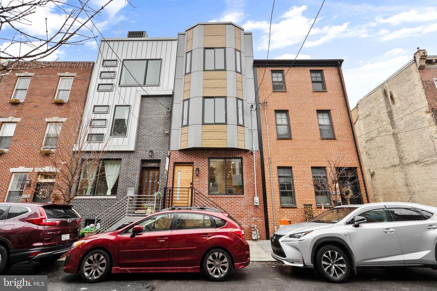 Welcome to 1032 S, Randolph Street, a stunning new construction residence located in the coveted Queens Village. **Estimated $85,000 tax savings over the course of the rarely offered FULL 10 year tax abatement** Thoughtfully designed with a traditional open-concept floor plan and elegant finishes in the heart of Queen Village.  The first floor welcomes you with a spacious, light-filled living and dining area that flows seamlessly into a corner kitchen at the rear of the home. A sturdy feel from the engineered hardwood floors throughout – warm, modern, and durable. The kitchen features sleek cabinetry, premium over hung counter tops, the Samsung Bespoke appliance package, built in wine fridge, and ample prep space - exceptional for those who love to cook and entertain. Leading to a raised deck patio, creating a cozy extension of your living space for morning coffee or summer evenings with friends. This home is equipped with smart features such as – Cameras, locks, thermostats & security at your fingertips. Upstairs, the second floor offers two generous bedrooms separated by a full bathroom and a convenient laundry area. The third floor is the crown jewel of the home - a private primary suite with three distinct areas: a spacious bedroom, a custom walk-in closet with built-in cabinetry, and a spa-like bathroom featuring heated floors, a dual vanity, and a luxurious shower. Finally, ascend to the 360° roof deck where you’ll enjoy sweeping city skyline views - the ultimate spot for hosting gatherings or relaxing under the stars. With smart home features including integrated security cameras, smart locks, and thermostats, you can control your home with the swipe of a finger. Schedule your showing today!