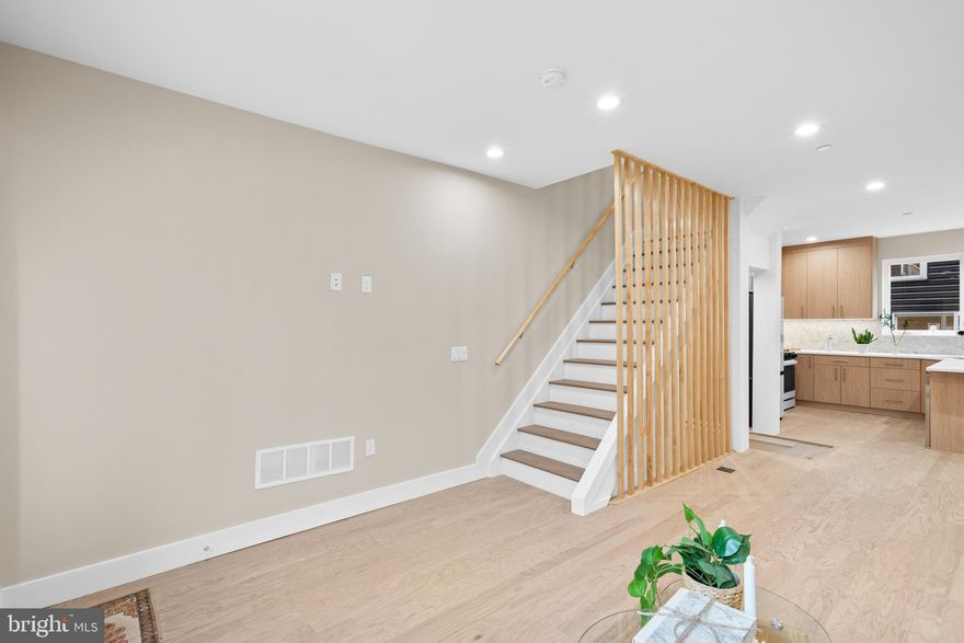 Welcome to 1032 S, Randolph Street, a stunning new construction residence nearing completion this month located in the coveted Queens Village. Thoughtfully designed with a traditional open-concept floor plan and elegant finishes in the heart of Queen Village. **Rarely offered FULL 10 year tax abatement** The first floor welcomes you with a spacious, light-filled living and dining area that flows seamlessly into a corner kitchen at the rear of the home. A sturdy feel from the engineered hardwood floors throughout – warm, modern, and durable. The kitchen features sleek cabinetry, premium over hung counter tops, the Samsung Bespoke appliance package, built in wine fridge, and ample prep space - exceptional for those who love to cook and entertain. Leading to a raised deck patio, creating a cozy extension of your living space for morning coffee or summer evenings with friends. This home is equipped with smart features such as – Cameras, locks, thermostats & security at your fingertips. Upstairs, the second floor offers two generous bedrooms separated by a full bathroom and a convenient laundry area. The third floor is the crown jewel of the home - a private primary suite with three distinct areas: a spacious bedroom, a custom walk-in closet with built-in cabinetry, and a spa-like bathroom featuring heated floors, a dual vanity, and a luxurious shower. Finally, ascend to the 360° roof deck where you’ll enjoy sweeping city skyline views - the ultimate spot for hosting gatherings or relaxing under the stars. With smart home features including integrated security cameras, smart locks, and thermostats, you can control your home with the swipe of a finger. Schedule your showing today!