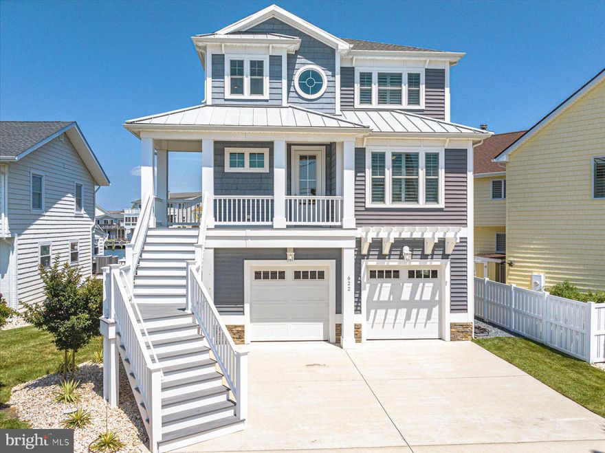 MOTIVATED SELLER! Bring all offers! Have you been searching for your dream home in the town of Ocean City? Look no further than 622 N Pacific! Located in the desirable midtown community of Little Salisbury, this home embodies the epitome of coastal living. With a private dock with two slips, one containing a 20,000 lb lift, there’s plenty of space for your boat, jet skis, paddleboards, kayaks and more. The location offers quick access to the bay plus a secluded setting away from Coastal Hwy while still allowing for the convenience and allure of living in town close to the beach, restaurants, entertainment and more. This three bedroom, two and a half bath home was thoughtfully designed and built in 2017. Everywhere you stand inside the home provides views to outside and the upgrades inside truly separate it from the rest. From the moment you enter into the two-story foyer, you can see that the property has been meticulously maintained and looks brand new. At the entry, you will find a bonus space that can be used as a den, office or a potential 4th bedroom, with pocket sliding doors for the option of privacy. As you walk down the hall to the main living area, you will pass the main floor powder room, a coat closet for extra storage and access to the elevator. There is also a full size laundry room with  access to the garage below. As you enter the open space of the living room, dining area and kitchen, you’ll be captivated by the tranquil water views. The kitchen is equipped with all GE Profile appliances, custom soft-close cabinetry and granite countertops. Storage is never lacking with a huge walk-in pantry. The peninsula with bar top seating and the large 8 seat dining table allows for plenty of opportunities to host and entertain. Let’s not forget the extra room outside, with another dining table on the second level deck, which provides incredible views out to the bay. Upstairs, you will find two oversized guest bedrooms, a full bath and the amazing master suite. The master is an owner’s oasis, containing a walk-in closet and the en-suite bathroom of your dreams, with two separate private toilets, dual vanities with a ton of storage, a large built-in soaking tub and a huge tiled walk-in shower. The master suite also provides access to your own private balcony, to sit and enjoy the sunsets every evening over the water. The attentiveness to detail when building the home really shows throughout. The commercial grade plank flooring, recessed lighting, solid core doors, higher ceilings, insulated interior walls and plantation shutters on windows that can withstand 150 mph winds are just a few features that will make you fall in love. Additionally, the home contains a tankless hot water system and a two system Carrier Infinity Series that humidifies automatically and constantly changes the air throughout the home. This home has been set up for any owner to have as little maintenance on the property as possible, with vinyl siding, vinyl bulkhead, automatic watering of the landscape and Trex decking. The oversized garage contains plenty of storage and could even be customized to accommodate extra living space. This is one you won’t want to miss out on seeing! Schedule your private showing today before it’s gone!
