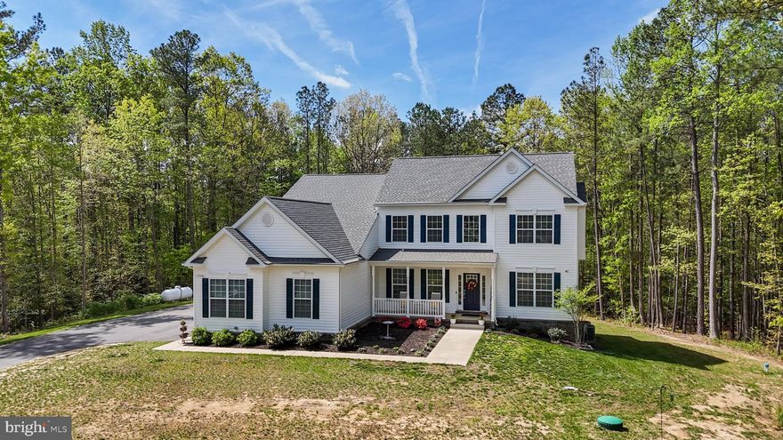 Welcome Home to 13301 Windjammer Court! Price Improvement!!!

This stately colonial, nestled on a 1.88-acre lot with beautiful wooded views, offers the perfect blend of privacy, space, and luxury living. Tucked away on an extended private driveway, you’ll enjoy peace, seclusion, surrounded by wooded views.



Boasting over 4,000 square feet above grade and an additional 2,238 square feet in the walk-out basement to be finished to your liking, this home provides all the space you need to live, work, and entertain in style.



Greeted by a charming colonial front porch, you'll step into a thoughtfully designed home featuring five spacious bedrooms, 4.5 bathrooms, and a three-car garage. Throughout the home, you’ll find upgraded luxury vinyl plank flooring—stylish, durable, and easy to maintain.



The open-concept main level includes a formal dining room, a welcoming great room with a cozy gas fireplace, and a dream kitchen outfitted with quartz countertops, double wall ovens, a gas-ready range hookup, an oversized island with bar seating, a walk-in pantry, and a bright morning room perfect for soaking in the sunshine and taking in the tranquil wooded surroundings.



The main-level bedroom suite offers convenience and comfort, with its own walk-in closet and full private bath—perfect for guests or multi-generational living.



Upstairs, escape to the massive owner’s suite, complete with a dream walk-in closet and a luxurious en-suite bath featuring double vanities, a soaking tub, separate shower, vanity counter, and a private water closet. Three additional bedrooms complete the upper level—two with private baths, and one with shared access.



No shortage of hot water here —this home is equipped with a tankless water heater to comfortably serve all 4.5 bathrooms. A spacious upstairs laundry room adds everyday convenience and functionality. Additionally these is another full laundry room with hook ups on the main level, again lending to the possibility of multigenerational living.



The walk-out basement offers an additional 2,238 square feet ready for your vision, with a full bath rough-in already in place. Whether you dream of a home theater, gym, guest suite, or rec room, this space is ready to become whatever your family needs.



Don’t miss this incredible opportunity to own a truly special home on a private 1.88-acre wooded lot in Hughesville, complete with high-end finishes and modern upgrades throughout.