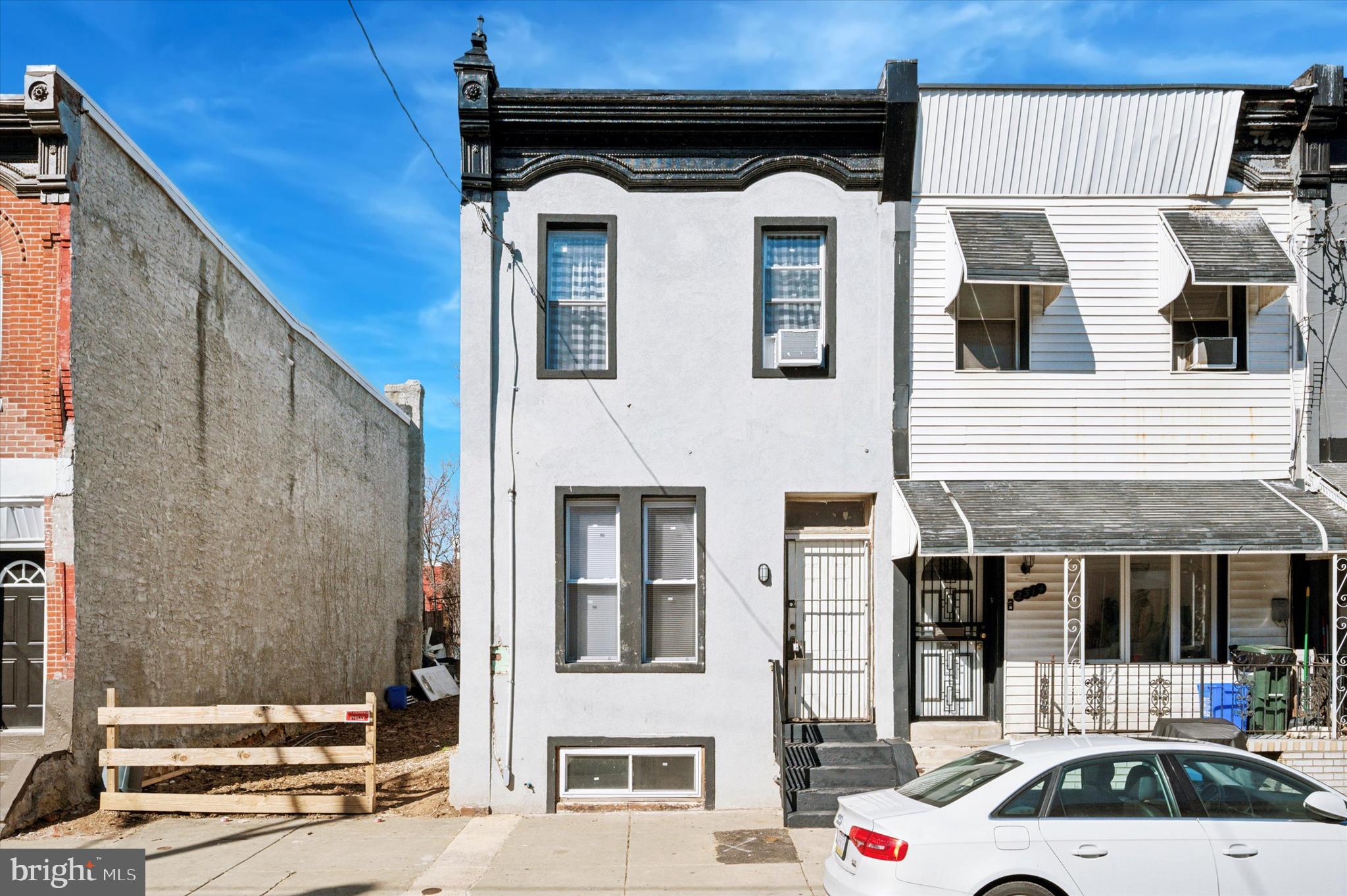 Fully renovated in 2024 is this light & bright 4 bedroom/ 2 full bath end-of-row home. Everything has been updated for you...open floor plan, luxury vinyl flooring, brand new kitchen and bathrooms, recessed lighting & fresh paint throughout, and the list goes on! Located just a few minutes walk to Temple University, this area has steadily increasing rents and high demand for a home of this caliber. Special attention was paid to details such as the custom black iron railings, faux fireplace detail, and the stunning modern kitchen. This kitchen has everything you want...modern dark cabinetry with gold hardware, island for extra seating & prep space, brand NEW gas range and refrigerator, quartz countertops, and subway tile backsplash! Convenient full bathroom on the main floor. The living room features a nook with a huge sunny window, perfect for an office setup or hobby space. Upstairs, you'll find 4 good sized bedrooms and another brand new full bathroom. The icing on the cake is the finished basement which adds 500+ Square Feet of living space to the home. Complete with drywall and recessed lighting, all you need is to install the flooring of your choice to make it the place where everyone will want to watch the game on Sunday. Roof was recently replaced. Central Air & efficient Gas Heat. This home packs so much value into 2,000SF+ of living space...hurry to secure your next investment in this sought-after area!