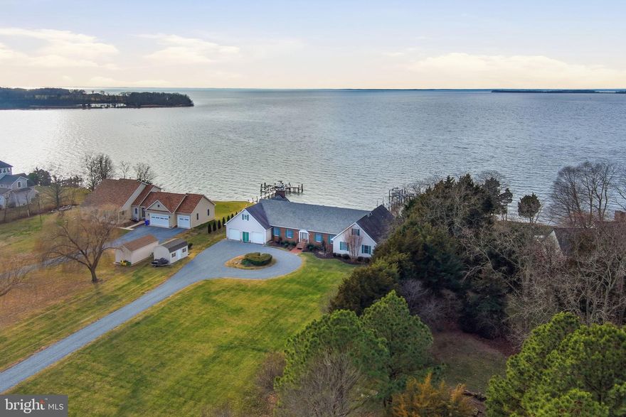 Chesapeake Bay Waterfront with Breathtaking Views. Experience exceptional waterfront living in this custom-built 5,240 sq ft residence, beautifully situated on an elevated bluff in the sought-after Great Oak Community of Chestertown, Maryland. Offering 5 bedrooms and 3.5 baths, this remarkable home captures sweeping Chesapeake Bay views and unforgettable sunsets from nearly every room. The property features 150 feet of riprap-protected shoreline and direct water access via a brand-new private 140ft pier complete with lighting, water service in four locations, a 12,000-lb boat lift, and two jet ski lifts—perfect for boating and waterfront recreation. Inside, the home impresses with 9-foot ceilings and hardwood floors throughout most of the main level. Designed for entertaining, the gourmet kitchen showcases luxury appliances, a distinctive chef’s cutting-board countertop, and new LVP flooring. The grand great room is a true showpiece, featuring a floor-to-ceiling brick wood-burning fireplace, vaulted shiplap pine ceiling, exposed beams, and views of the Bay! Additional living spaces include an elegant formal dining room, a spacious gathering room, and a casual dining area highlighted by a gas fireplace. The first-floor primary suite offers privacy and comfort with a walk-in closet and an updated bath featuring new flooring, a corner soaking tub, and dual vanities. Two additional bedrooms, a full bath, and a laundry room complete the main level. The second floor provides two generously sized bedrooms, a large living area, a full bath, and an 18’ x 22’ unfinished bonus room/man cave with a separate staircase offering access to the garage or exterior—ideal for future expansion or customization. Notable features include a new roof, an oversized two-car garage with workbench, a small basement housing a state-of-the-art temperature- and humidity-controlled wine cellar, a Culligan whole-house water filtration system, and two hot water heaters. One of the home’s most captivating spaces is the expansive screened-in porch, stretching across much of the waterfront side of the home. With three ceiling fans and panoramic Chesapeake Bay views, it offers the perfect setting for relaxing or entertaining year-round. Whether you’re seeking a serene waterfront retreat or a home designed for memorable gatherings, this exceptional coastal property delivers. Just minutes from historic Chestertown, home to Washington College, waterfront dining, farmers’ markets, parks, festivals, and river cruises. Conveniently located near Safe Harbor Great Oak Marina and approximately 90 minutes from Washington, D.C. and Philadelphia. Schedule your private showing and experience Chesapeake Bay living at its finest
